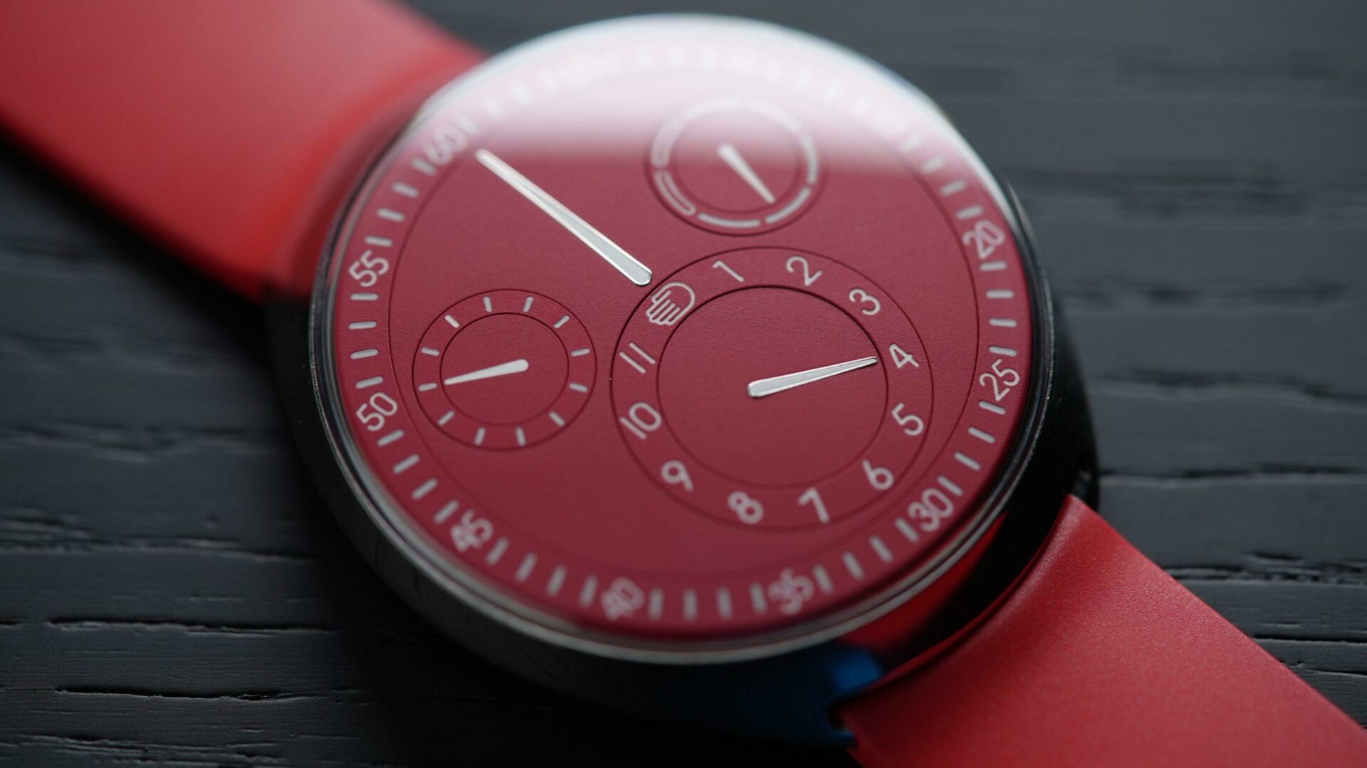 Ressence Type 1 Slim Red closeup reflected under white light.