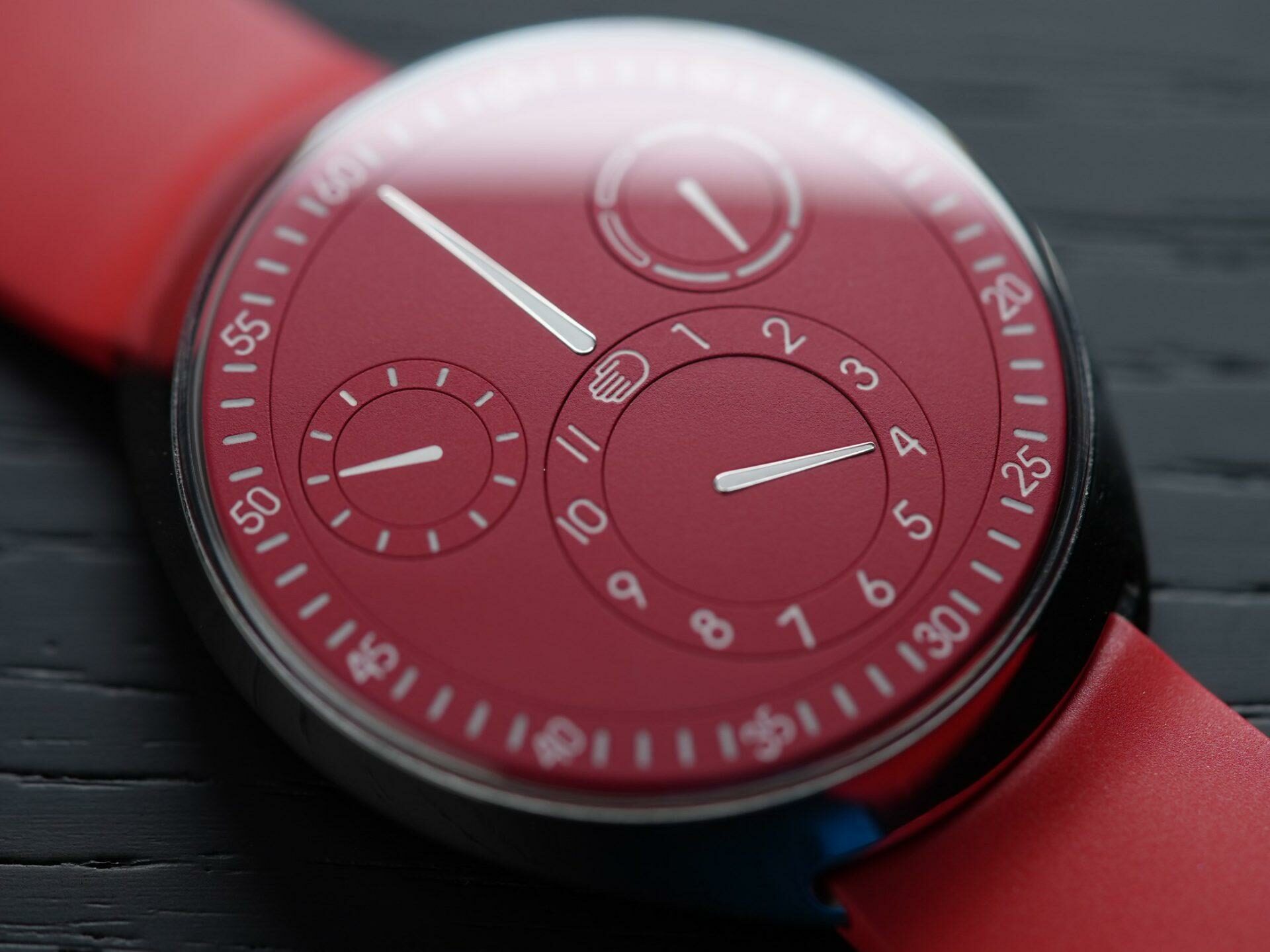Ressence Type 1 Slim Red closeup reflected under white light.