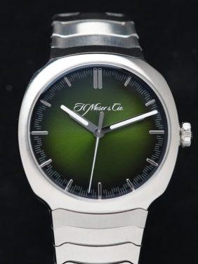 H.Moser & Cie. STREAMLINER CENTRE SECONDS Matrix Green fume being prominently centered and on display.