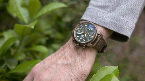 IWC Pilot Spitfire Chronograph Bronze Green on wrist outdoors.