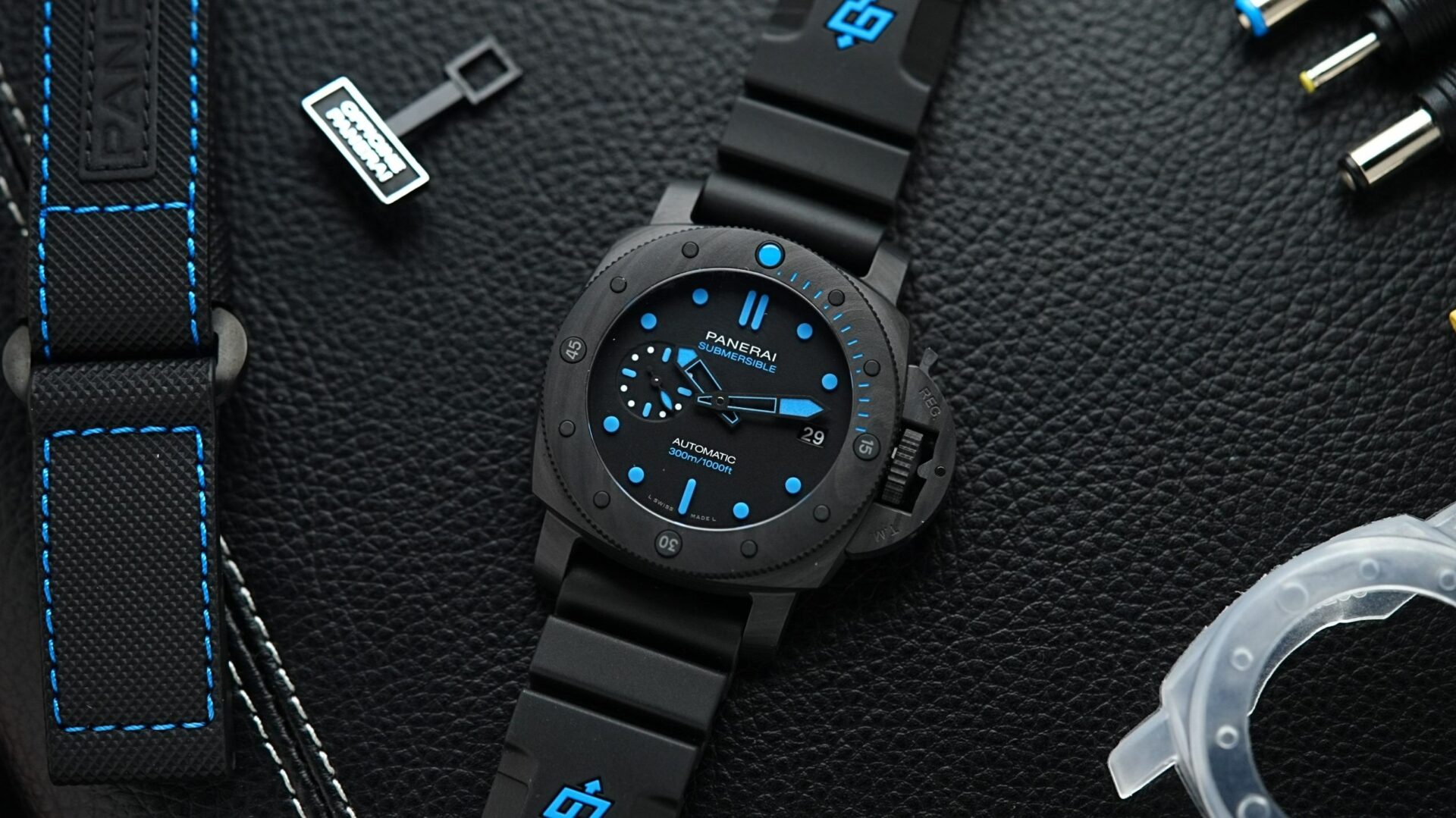 Panerai Submersible Carbotech PAM960 displayed with black background and props.