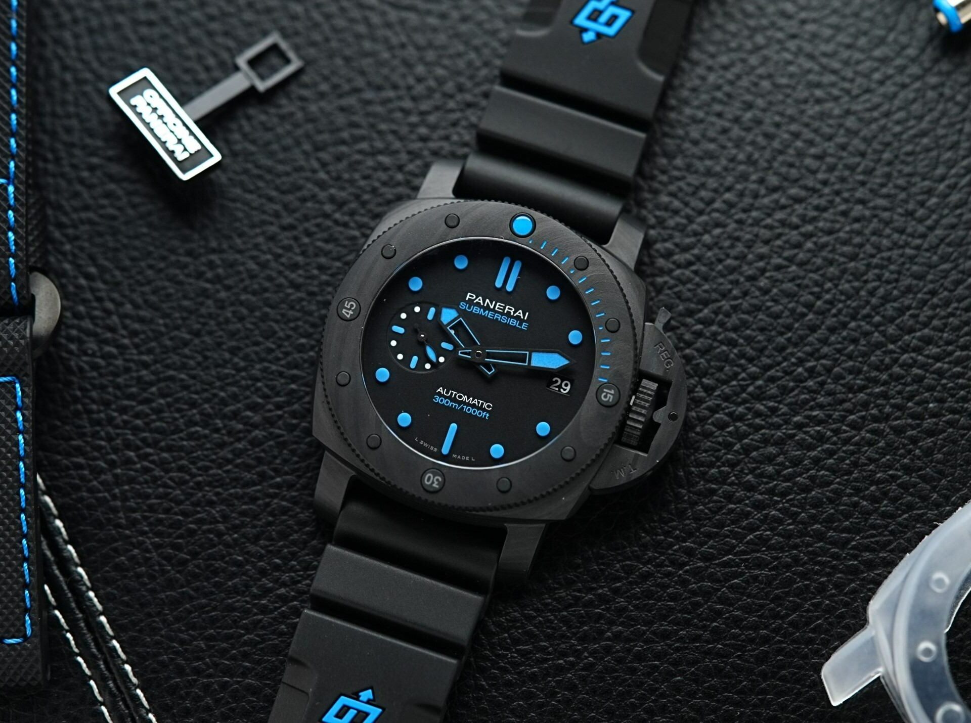Panerai Submersible Carbotech PAM960 displayed with black background and props.
