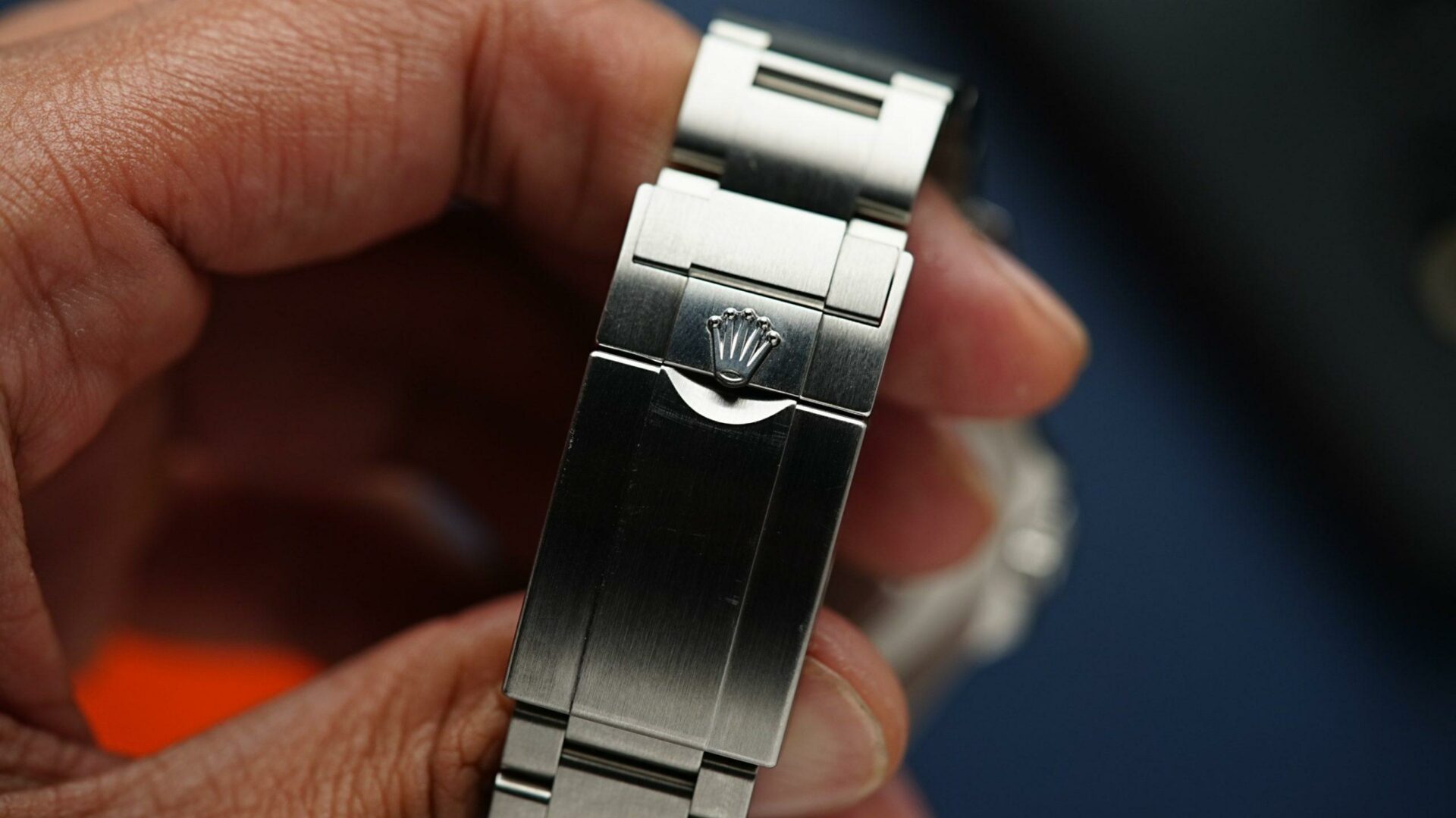 Clasp of the Rolex Explorer II 2022 216570 being displayed in hand up close.