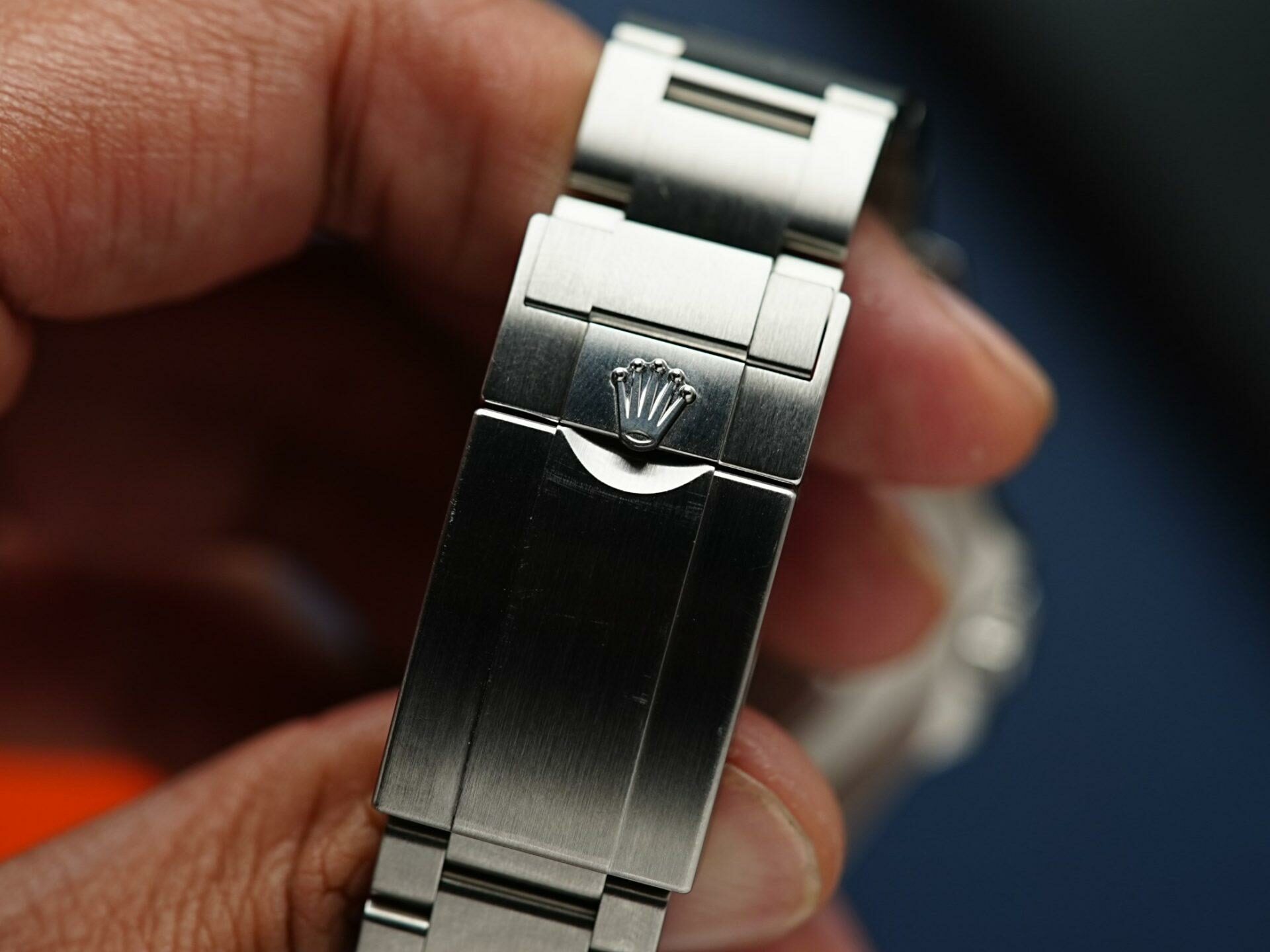 Clasp of the Rolex Explorer II 2022 216570 being displayed in hand up close.