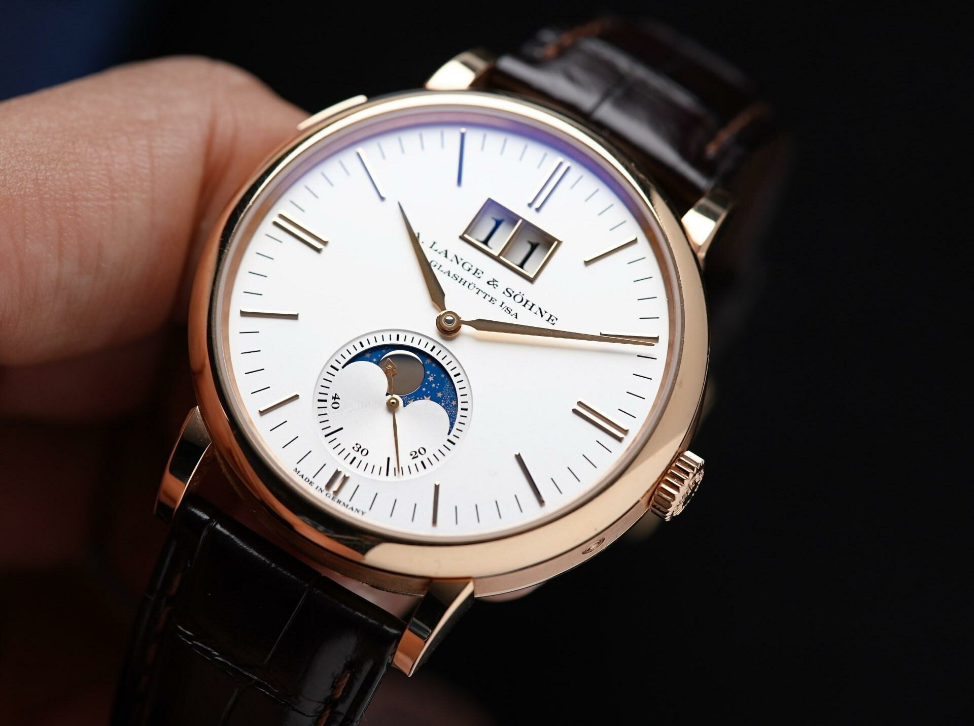 A. Lange & Söhne Saxonia Moon Phase Rose Gold held in hand.