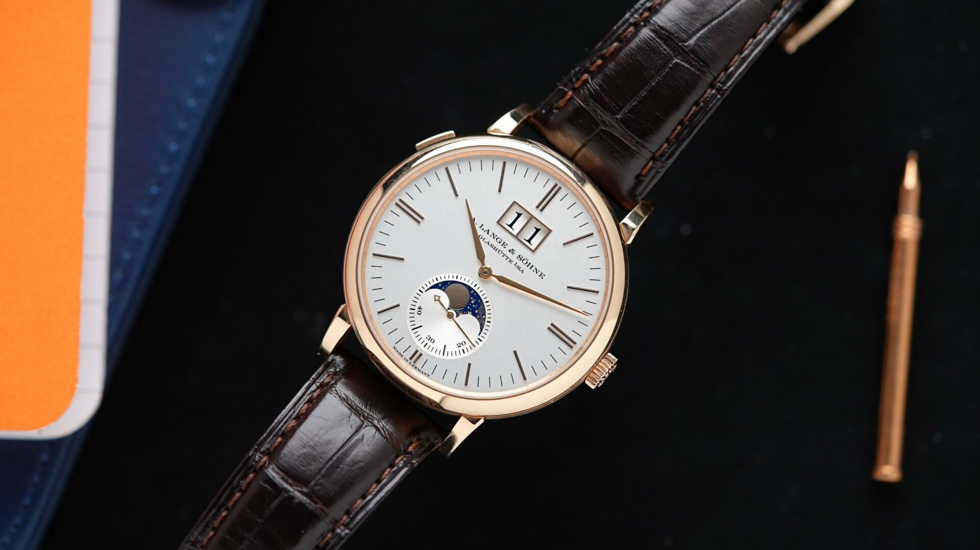 A. Lange & Söhne Saxonia Moon Phase Rose Gold featured under white lighting.