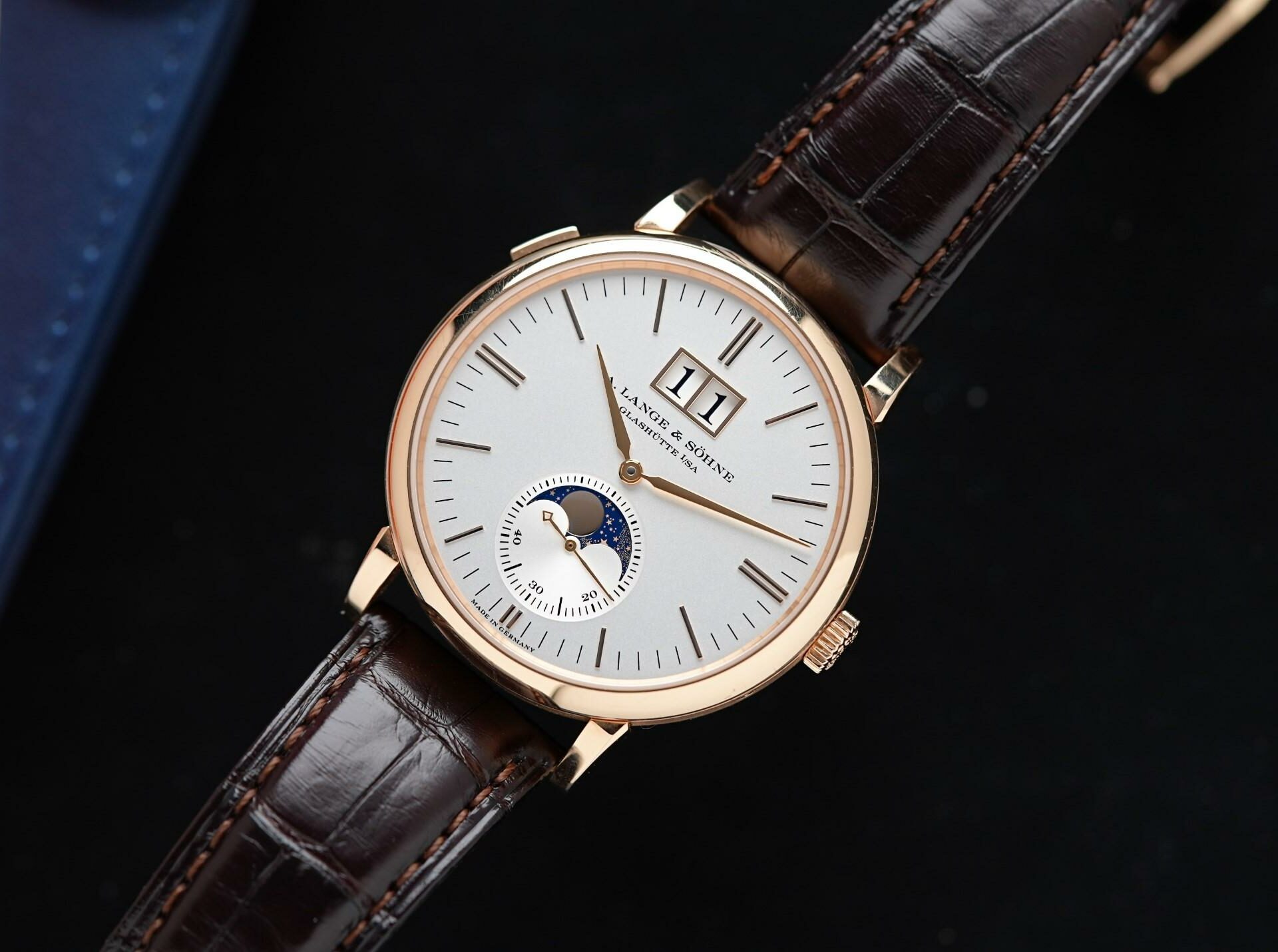 A. Lange & Söhne Saxonia Moon Phase Rose Gold featured under white lighting.