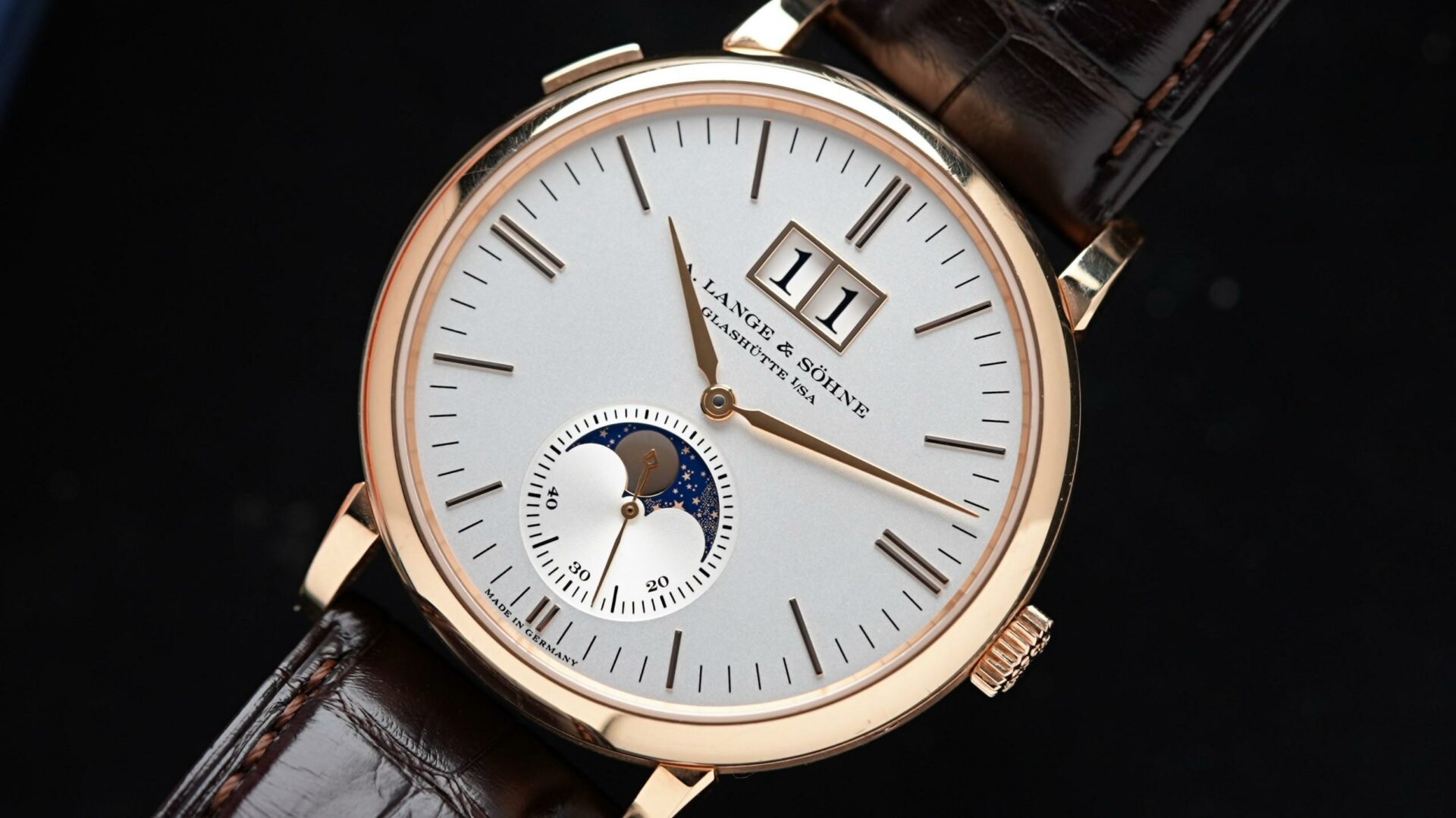 A. Lange & Söhne Saxonia Moon Phase Rose Gold featured under white lighting up close.