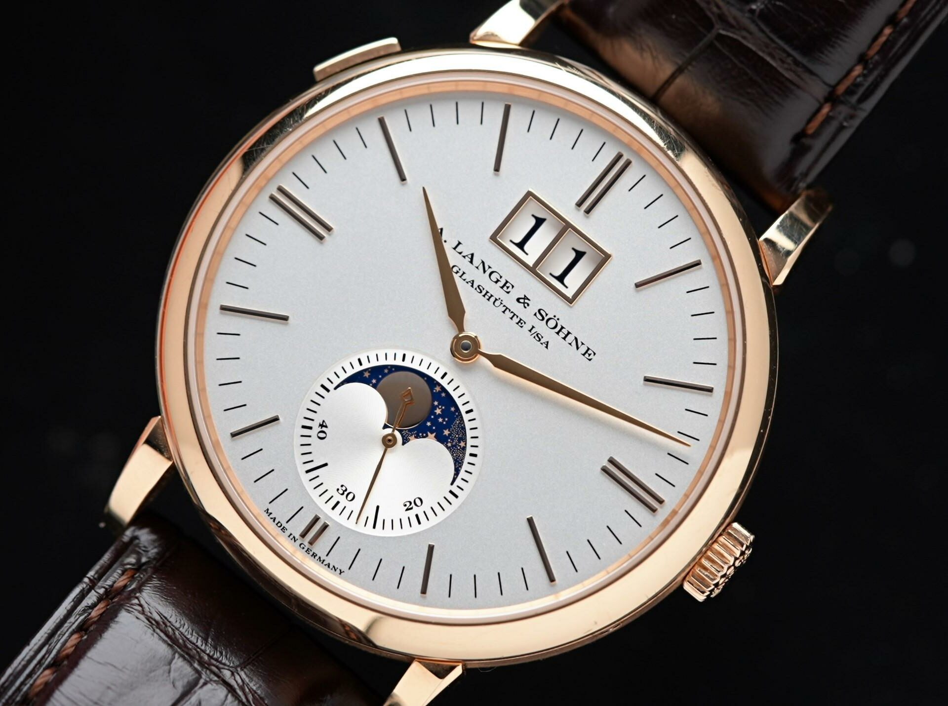 A. Lange & Söhne Saxonia Moon Phase Rose Gold featured under white lighting up close.