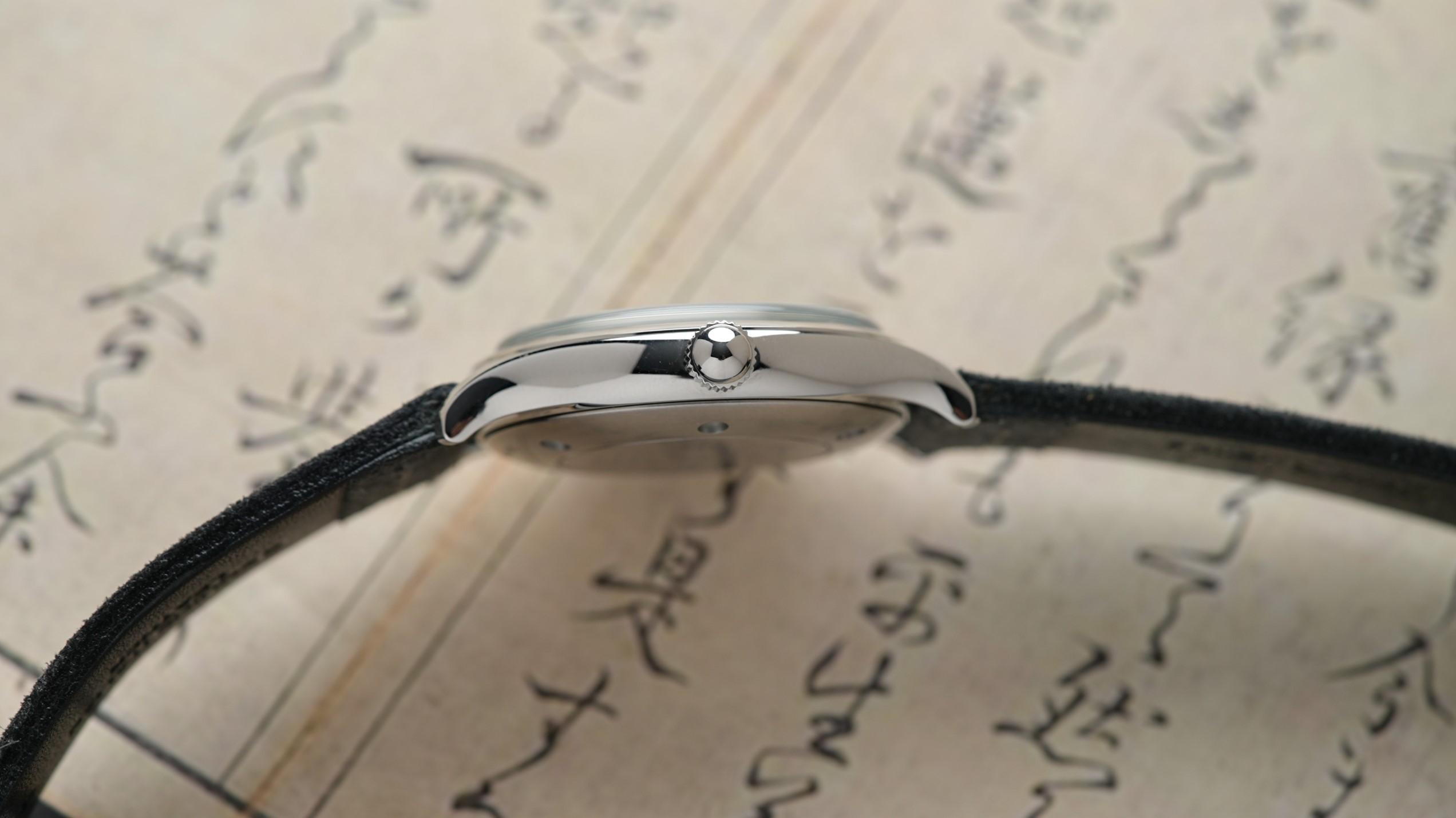Side view of the Kurono Tokyo Seiji LE Tiffany Blue Dial with Japanese manuscript background prop.