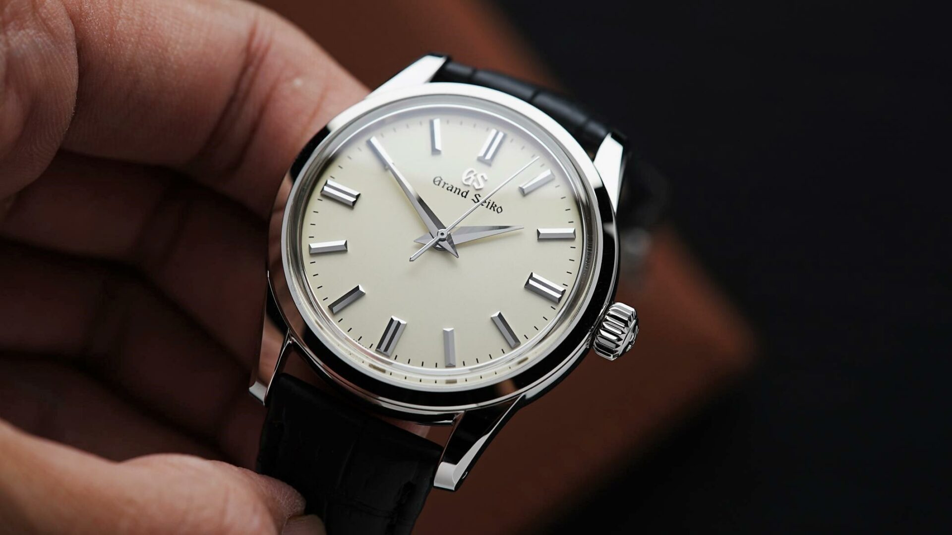 Grand Seiko SBGW231 being held in hand.