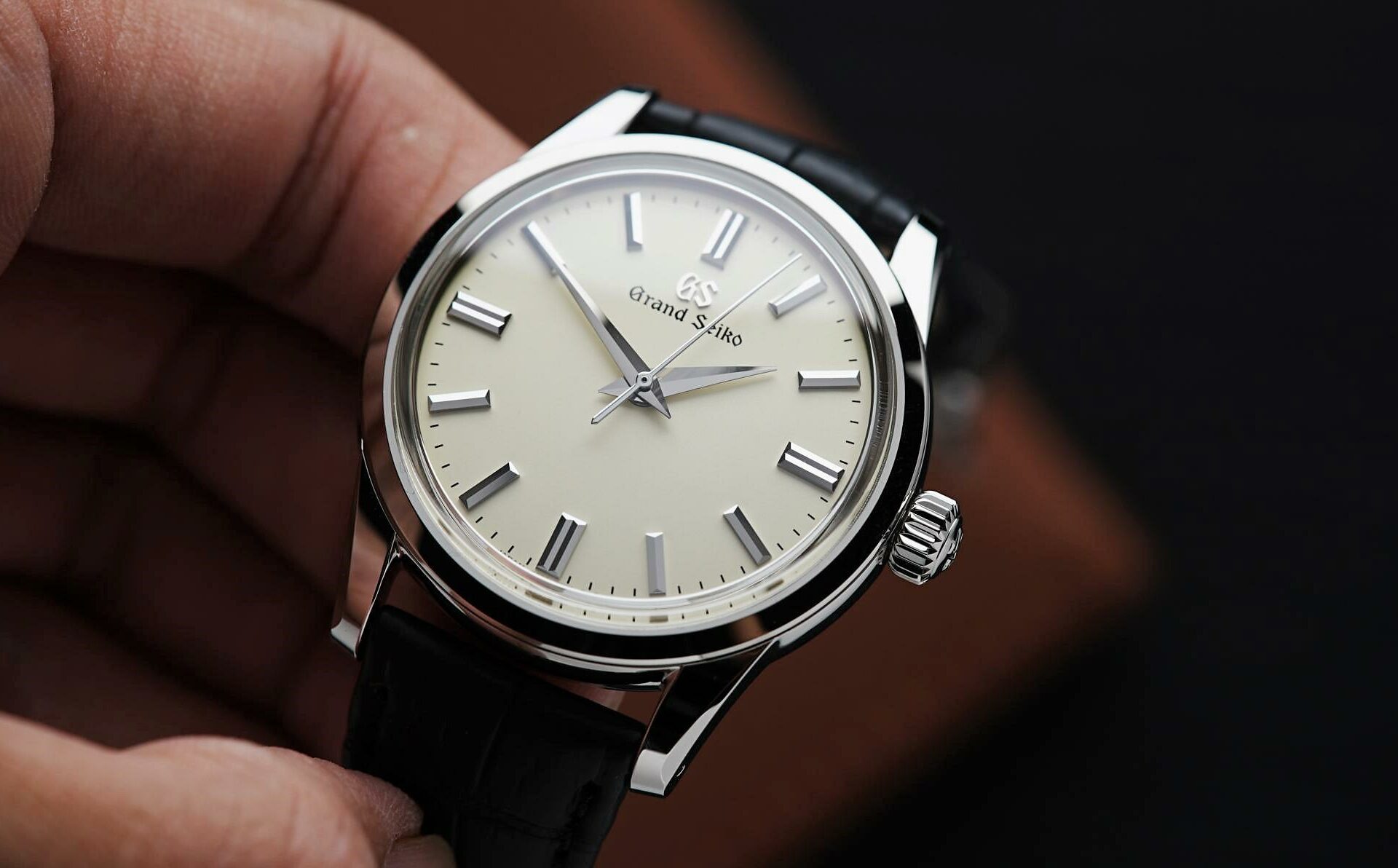 Grand Seiko SBGW231 being held in hand.