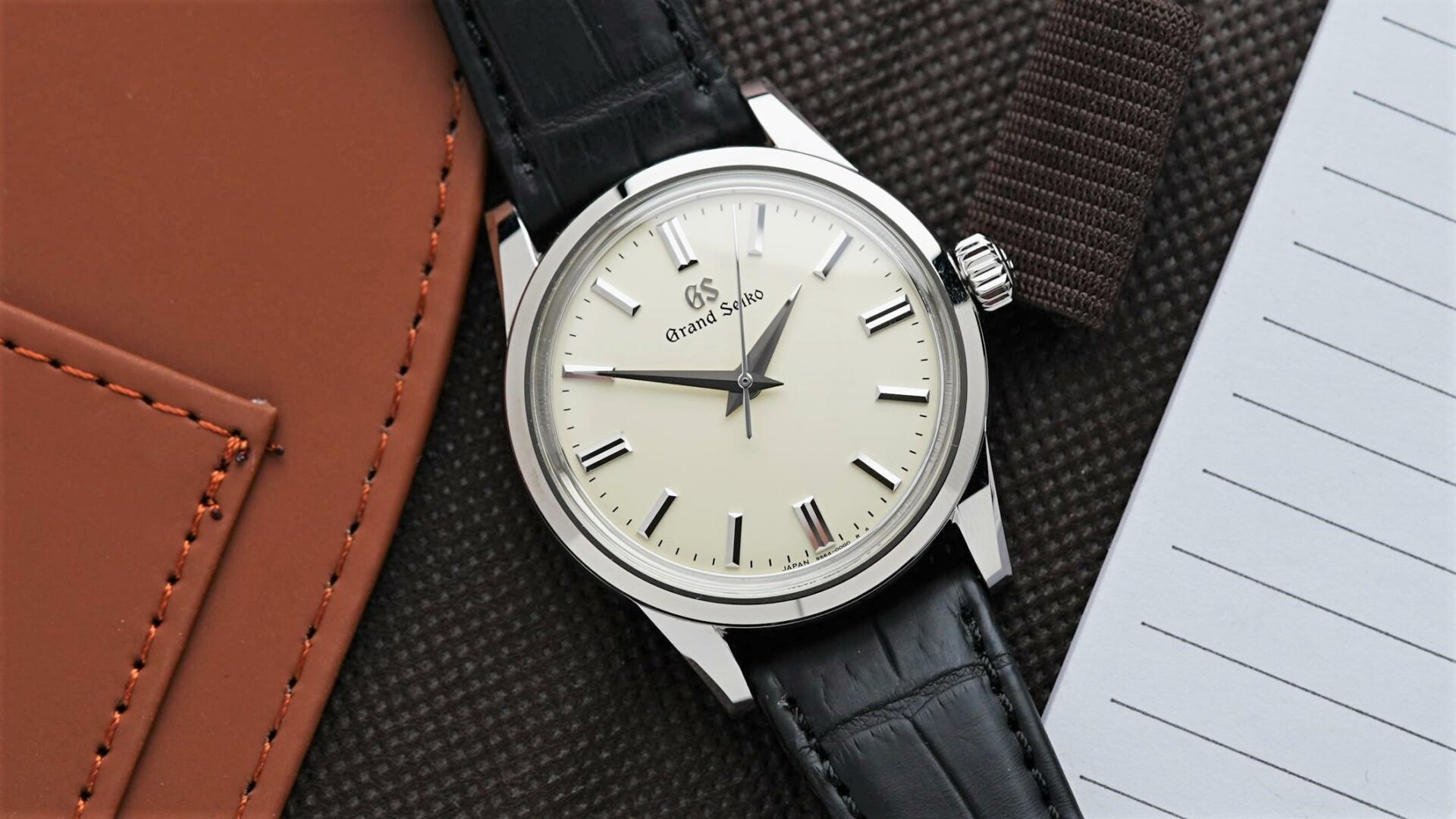 Grand Seiko SBGW231 featured beside notepad.