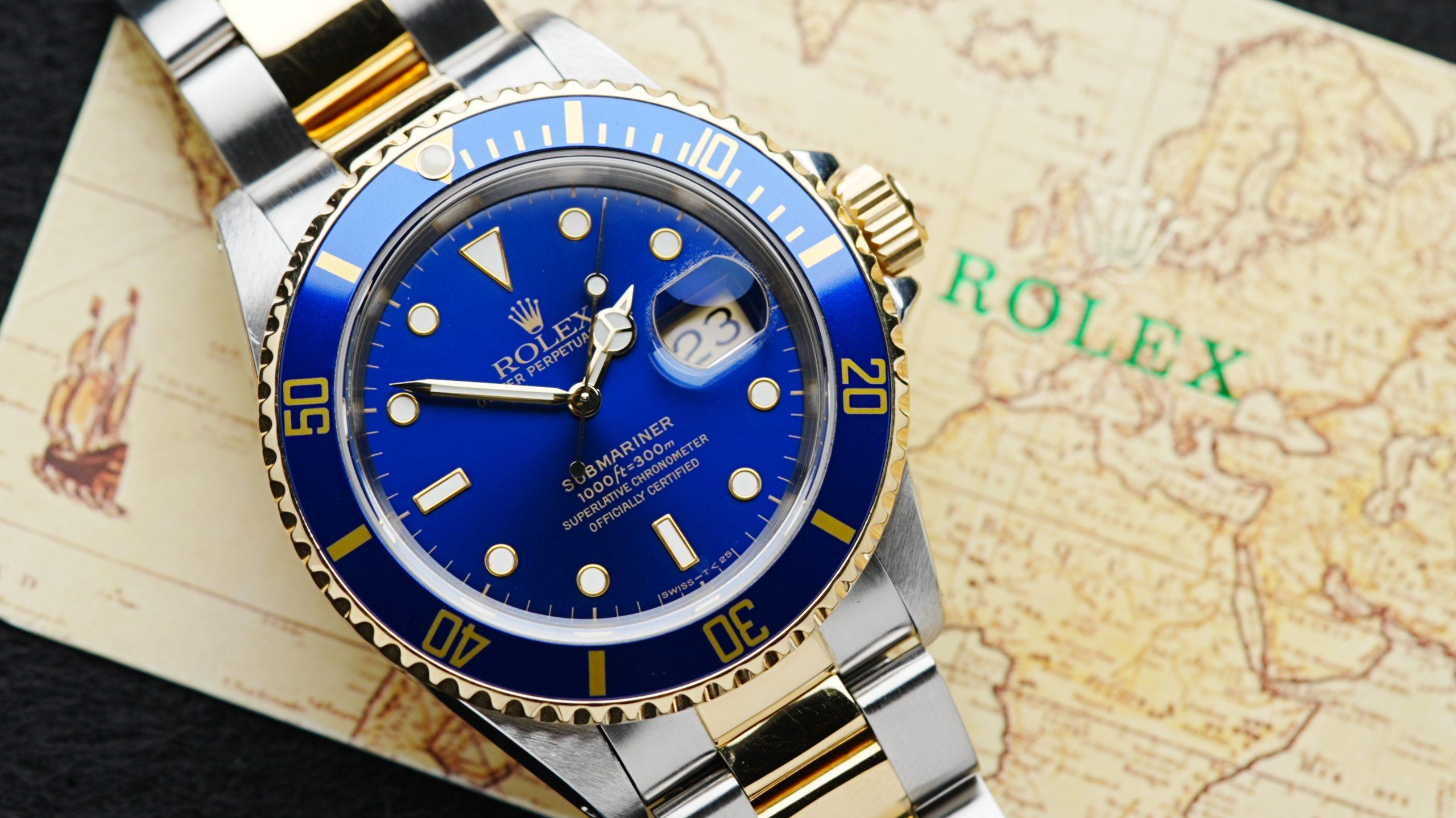Rolex Submariner Date Two Tone Blusey 1991 up close on Rolex map booklet.