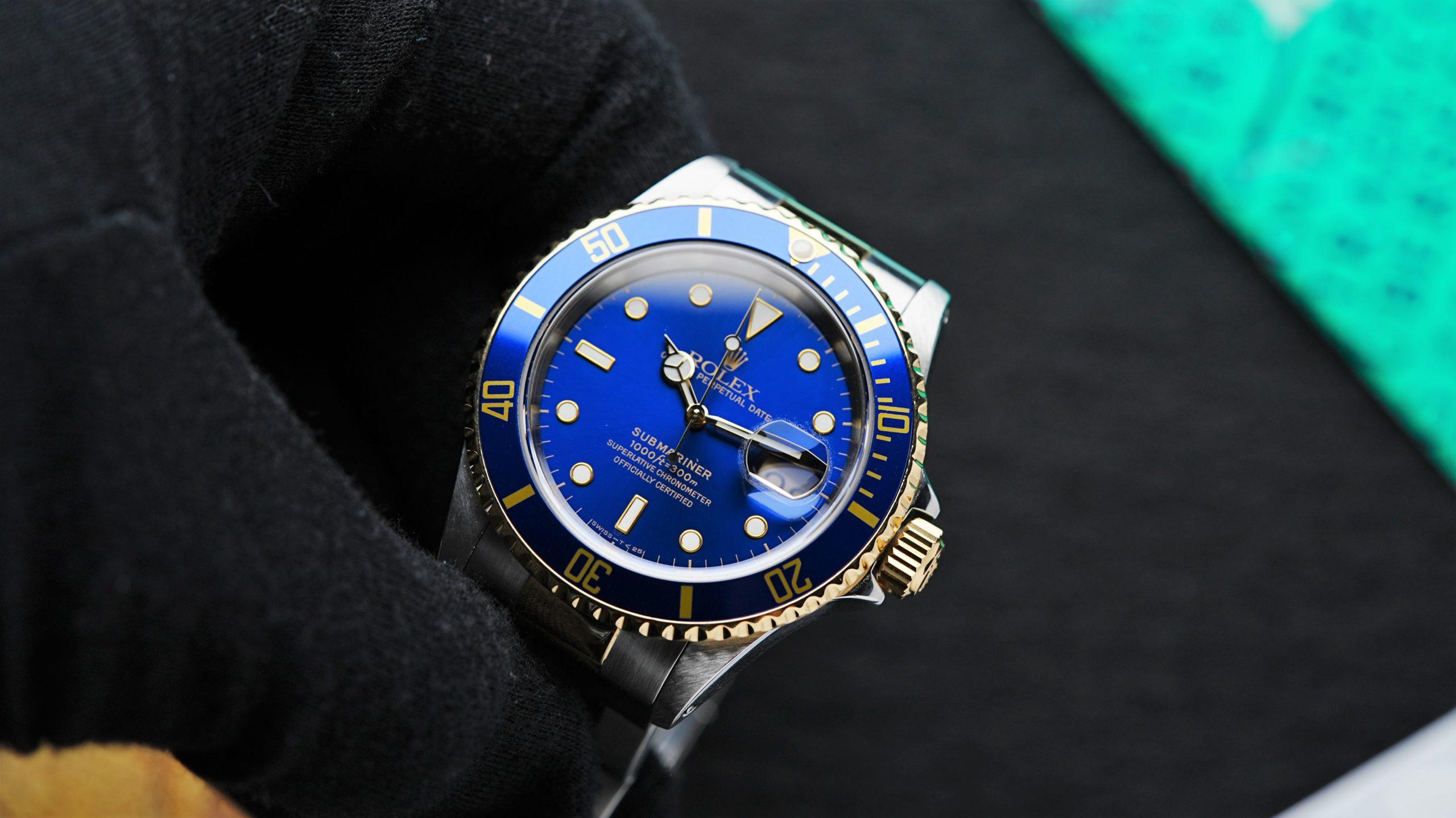 Rolex Submariner Date Two Tone Blusey 1991 being held in hand.