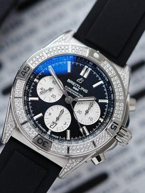 Diamond embezzled Breitling B01 42 Chronomat watch pictured on an angle under white light.
