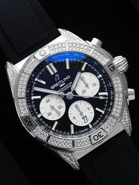 Diamond embezzled Breitling B01 42 Chronomat watch featured on an angle under white light.