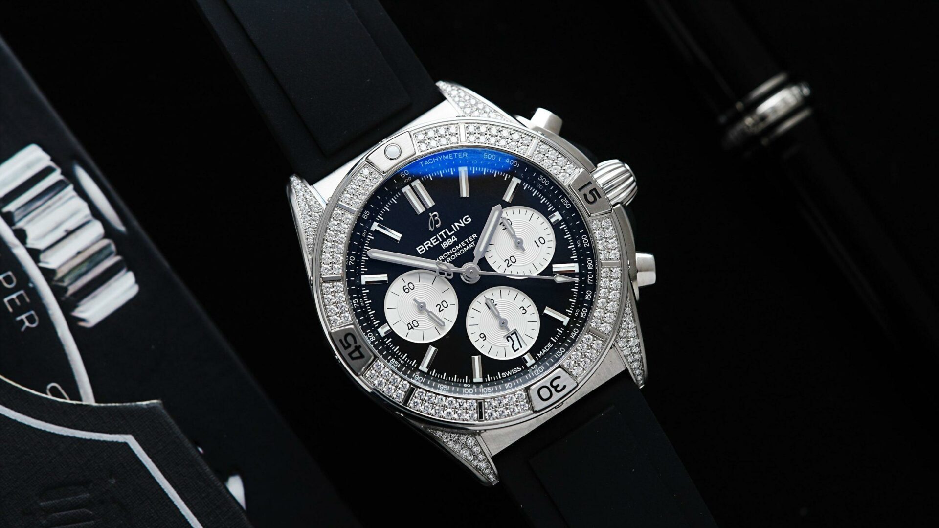 Diamond embezzled Breitling B01 42 Chronomat watch featured on an angle under white light.