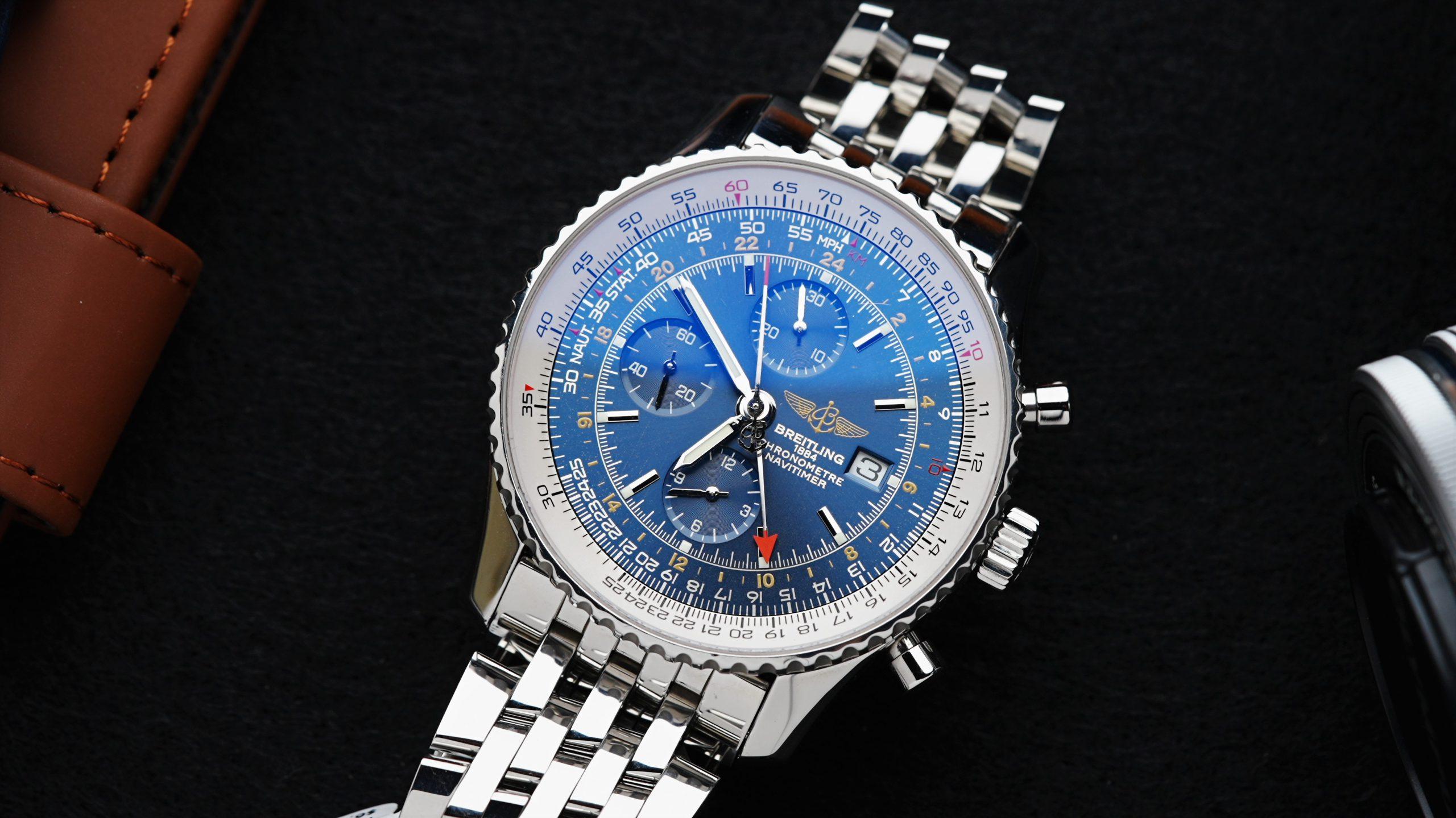 Breitling Navitimer 1 Chronograph Gmt 46 blue dial featured under white lighting on an angle.