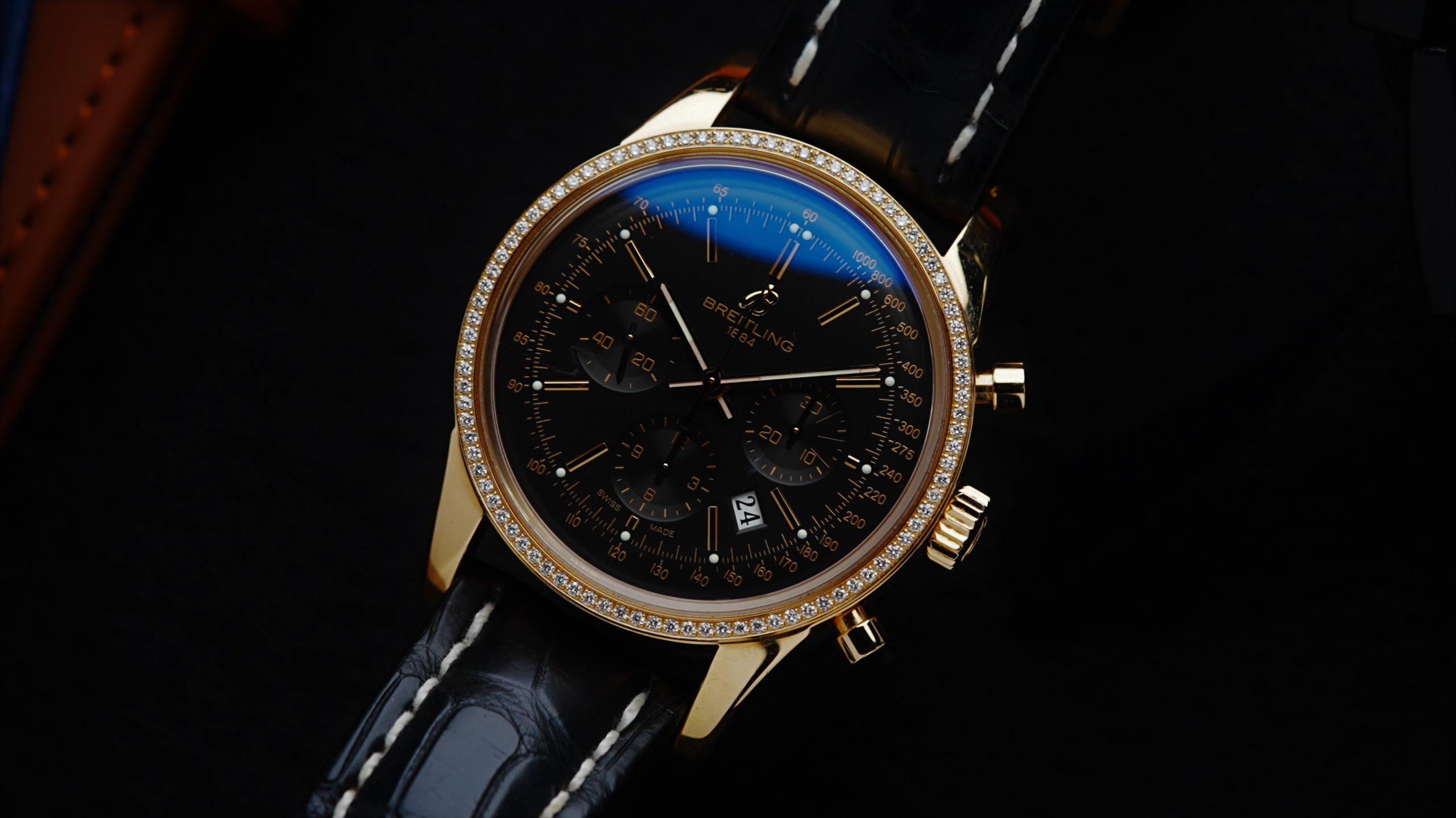 Breitling Transocean Chronograph Diamonds Rose Gold watch featured under white lighting on an angle.