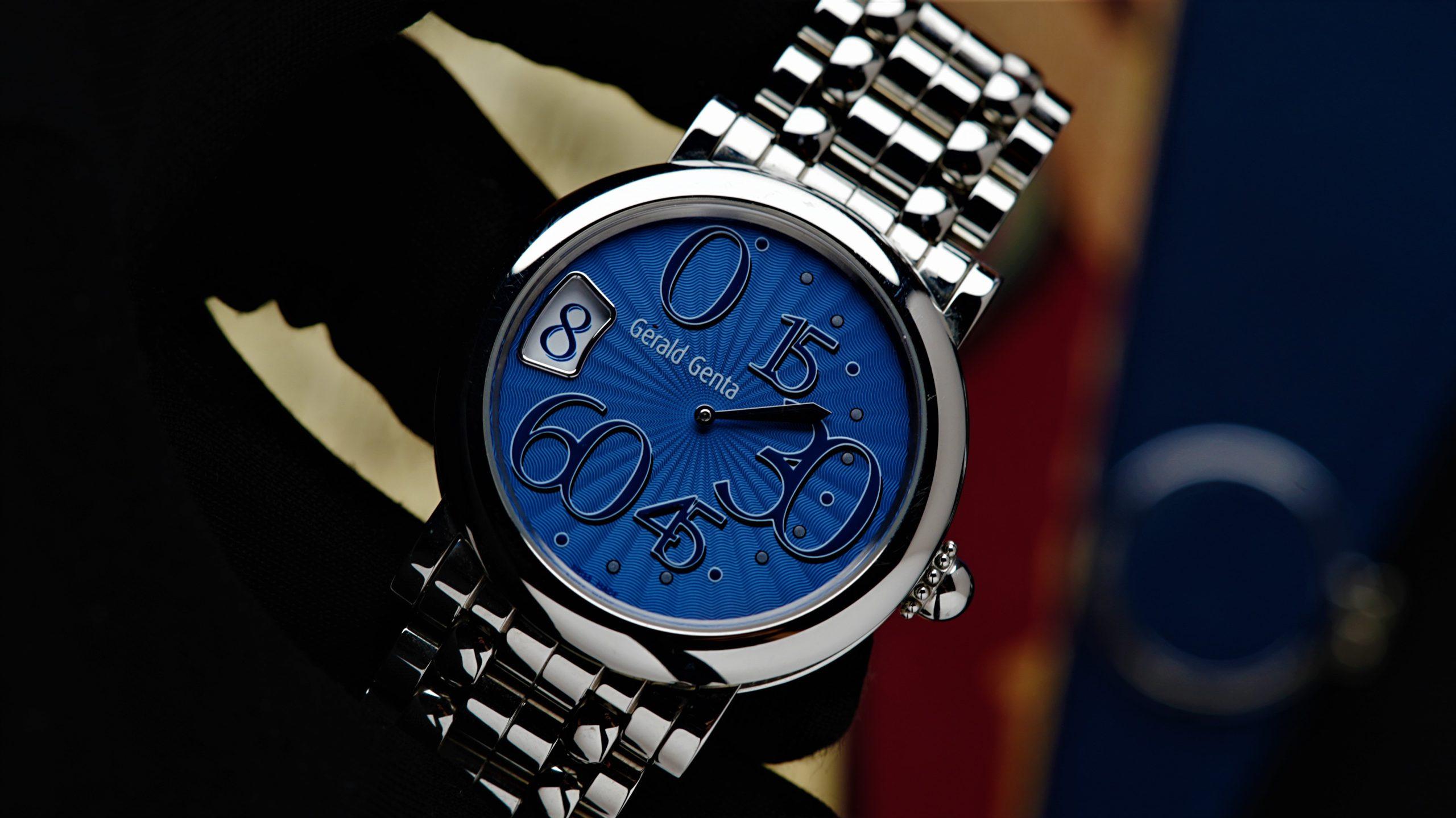 Gérald Genta Retro Classic Extremely Rare Blue Guilloche Dial Jump Hour watch being held in hand.