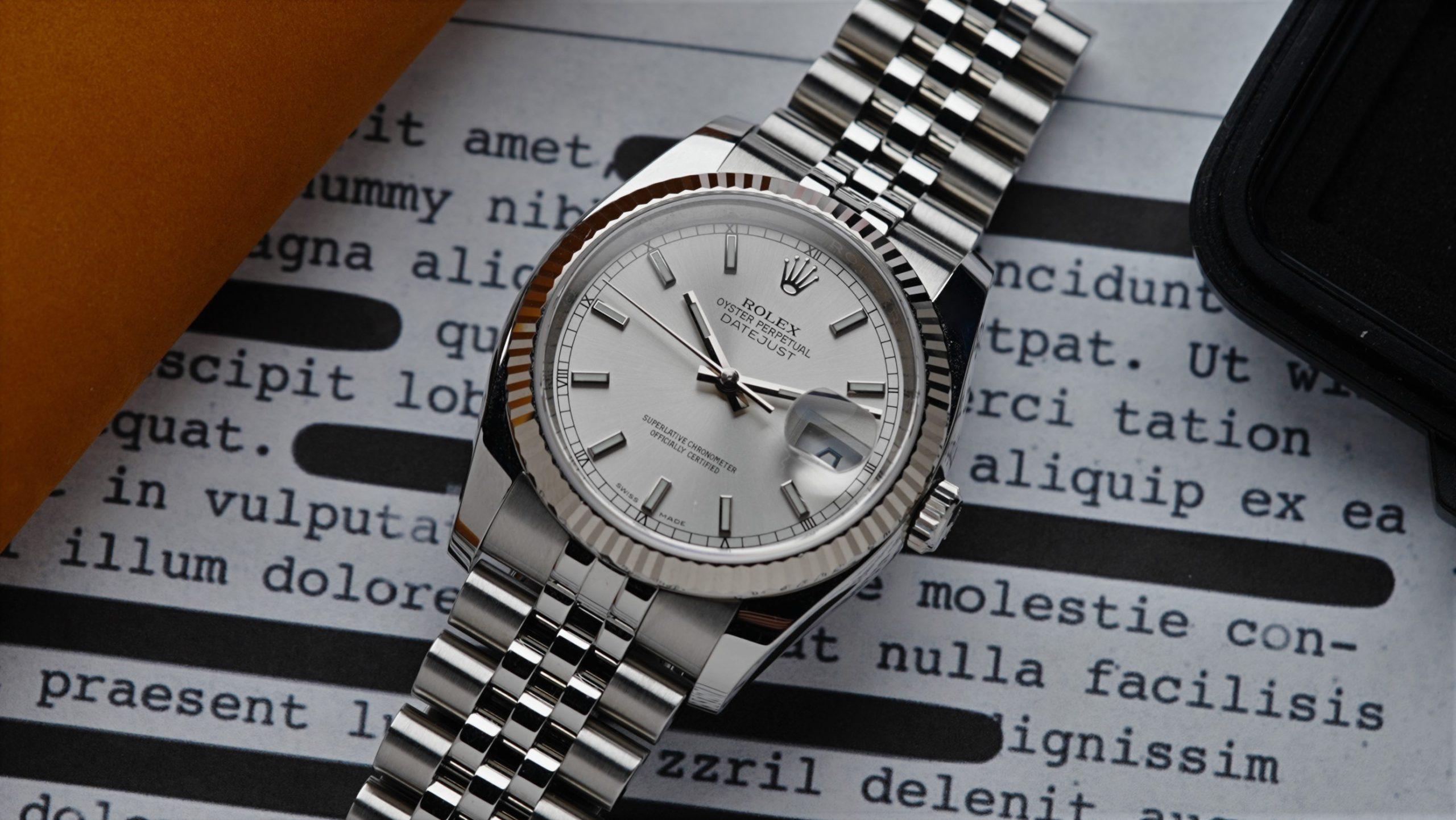 Rolex Datejust 36 Silver Dial watch with document in background.