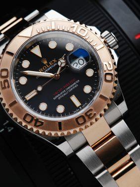 Rolex Yacht-Master 40mm watch with camera in background.