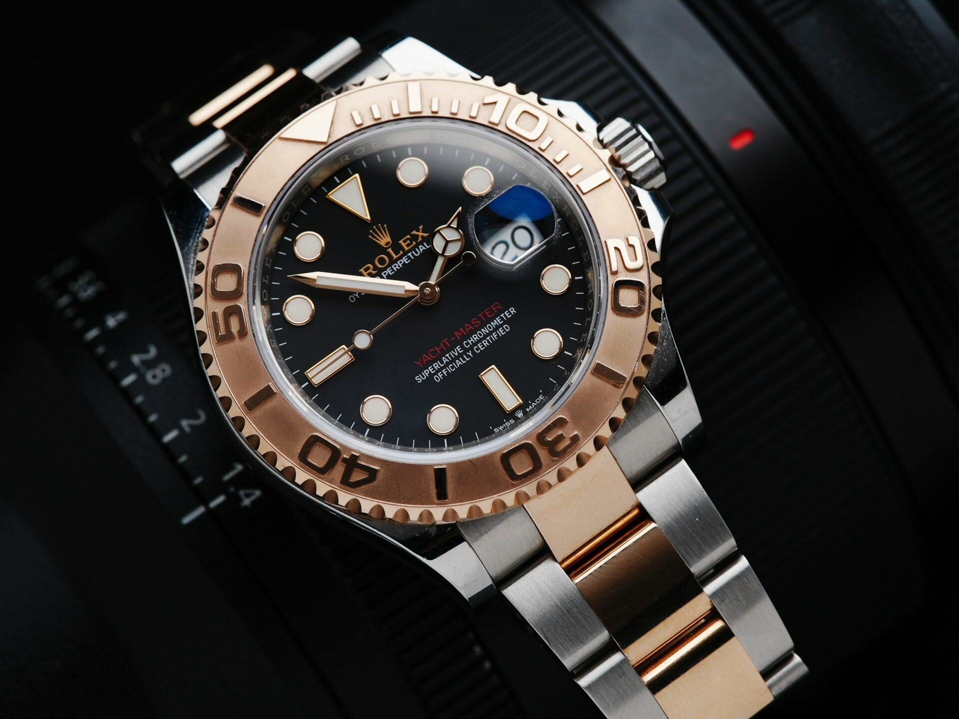 Rolex Yacht-Master 40mm watch with camera in background.