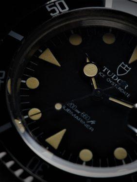 Tudor Submariner Lollipop Hands Perfect Patina 76100 watch zoomed in up close on dial.