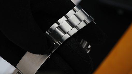 Closeup shot of the Tudor Submariner Lollipop Hands Perfect Patina 76100 watch bracelet under white light.