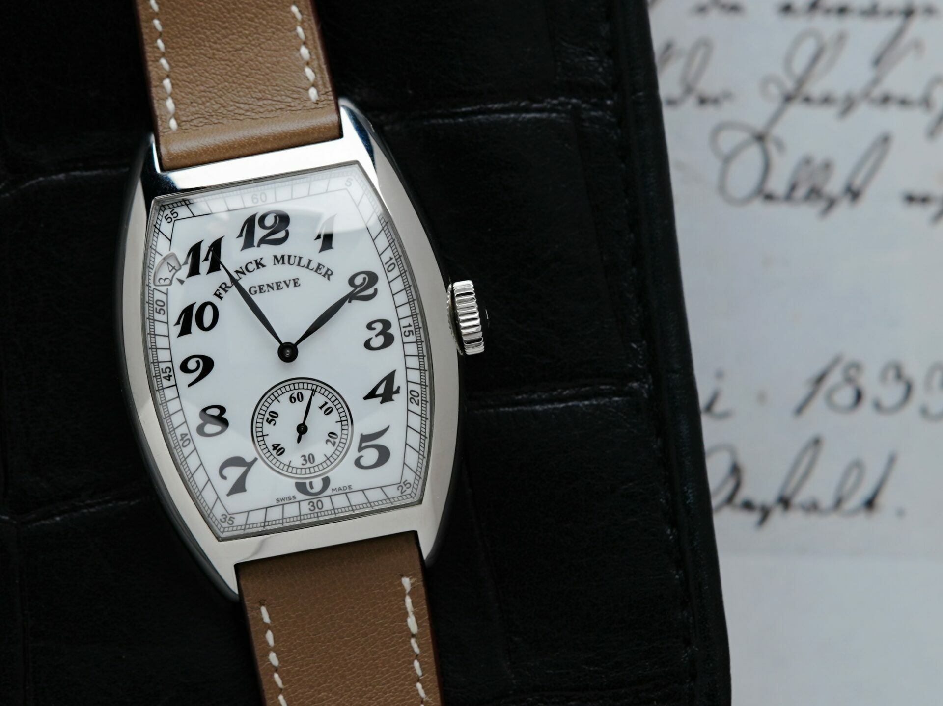 Franck Muller Vintage Curvex 7 Day Reserve watch with paper document in background.