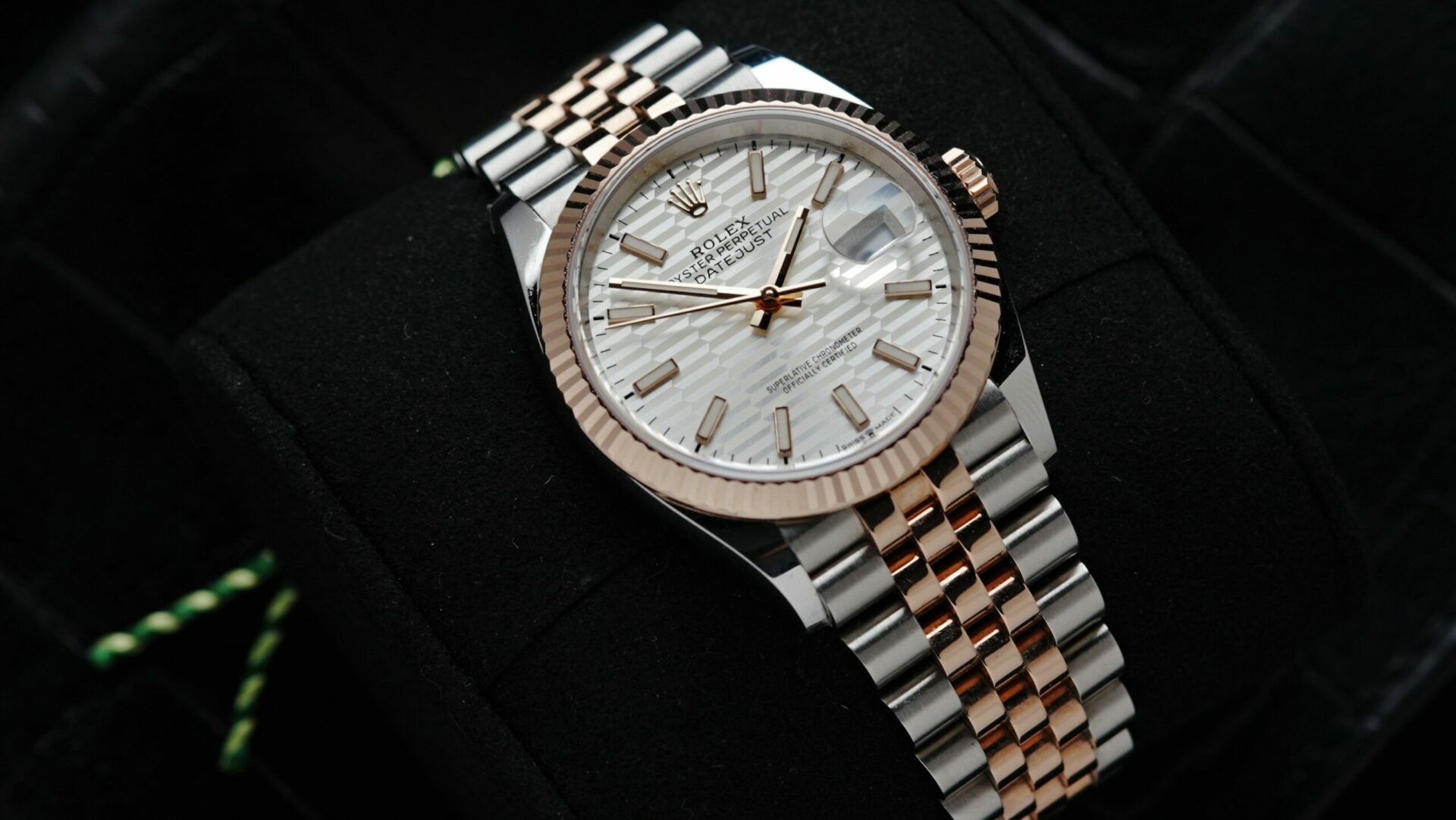 Rolex Datejust 36 Motif Rose Gold 2022 watch pictured on an angle under white light.