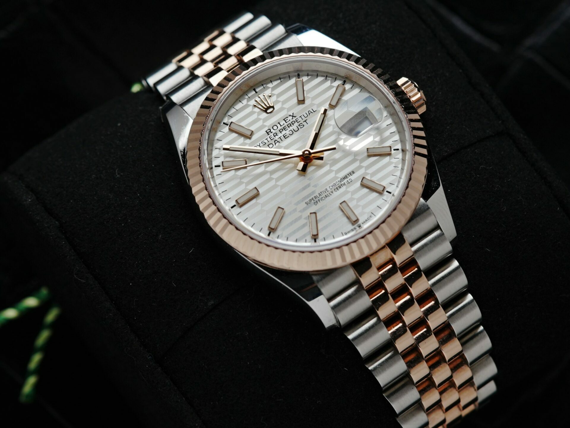 Rolex Datejust 36 Motif Rose Gold 2022 watch pictured on an angle under white light.