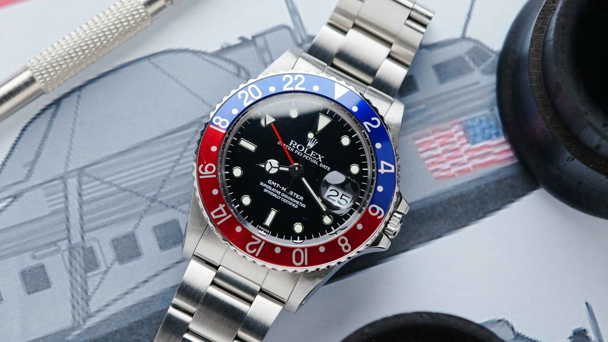 Rolex GMT-Master Pepsi watch displayed with picture of jet in background.