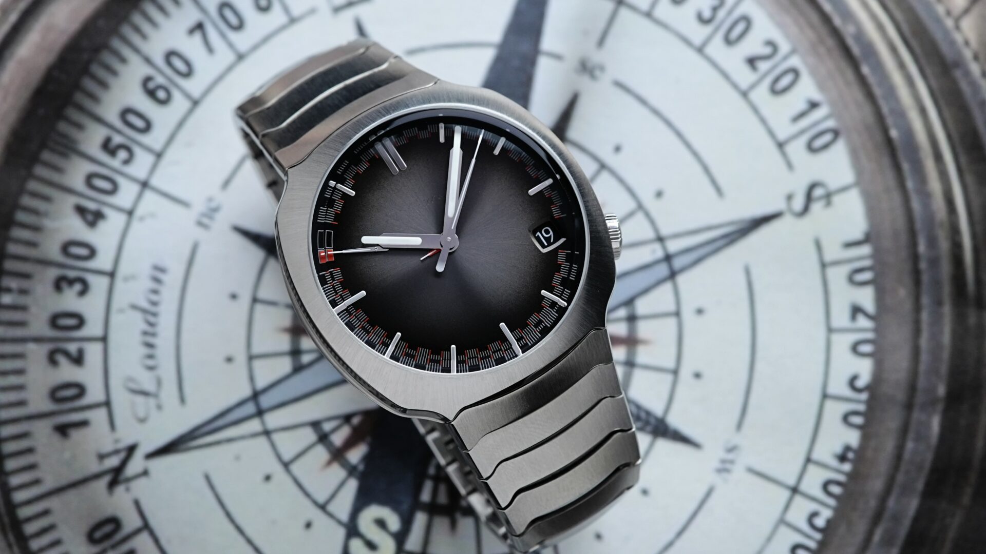 H.Moser & Cie. Streamliner Perpetual Calendar 6812-1200 watch featured on compass background.