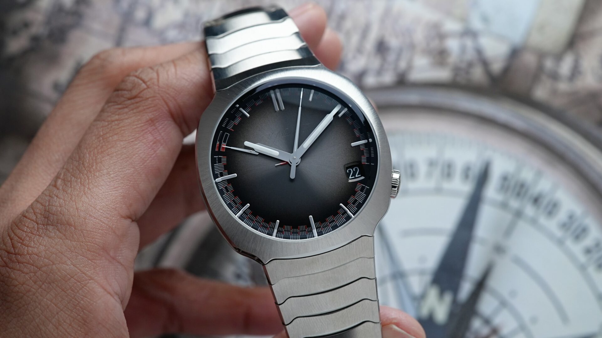 H.Moser & Cie. Streamliner Perpetual Calendar 6812-1200 watch being held in hand.