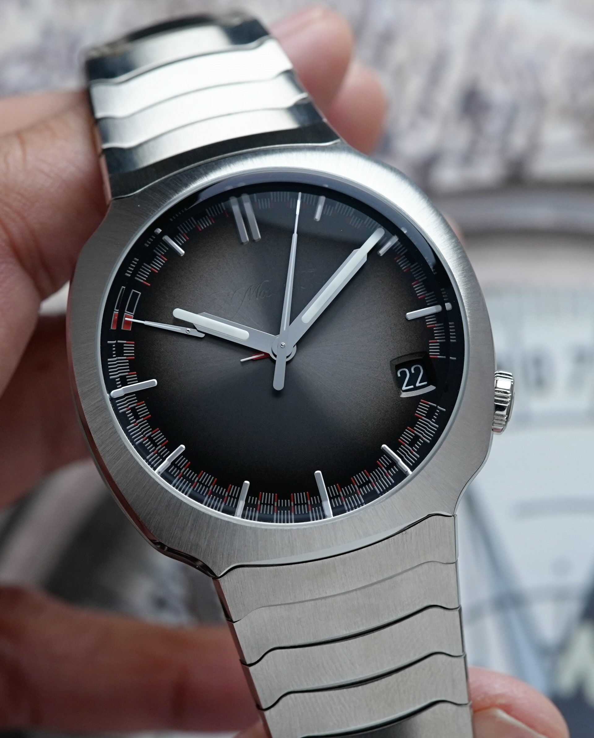 H.Moser & Cie. Streamliner Perpetual Calendar 6812-1200 watch being held in hand.