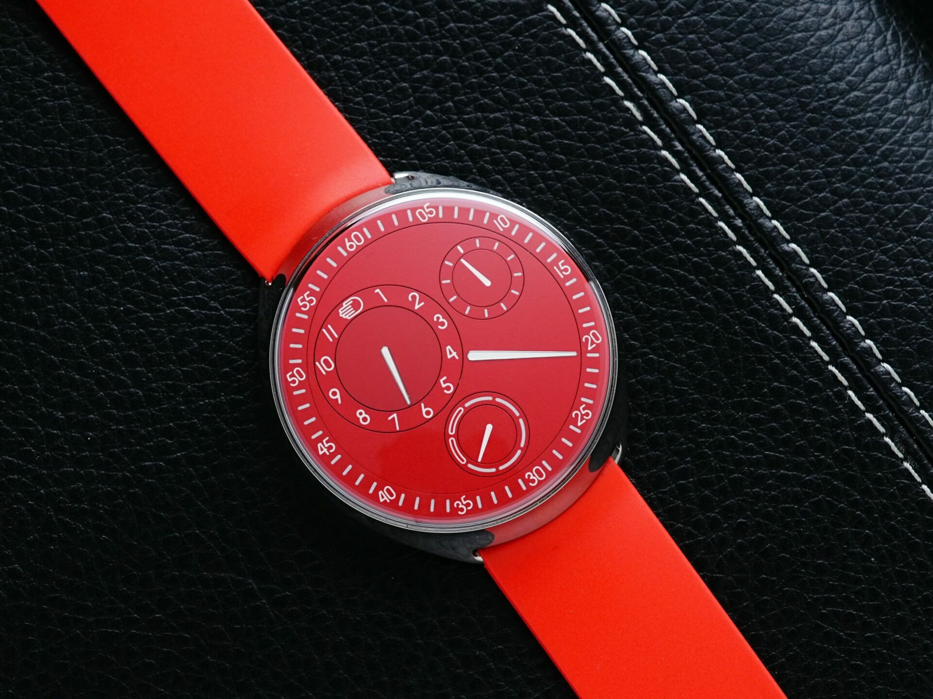 Ressence Type 1 Red Slim setting on leather.