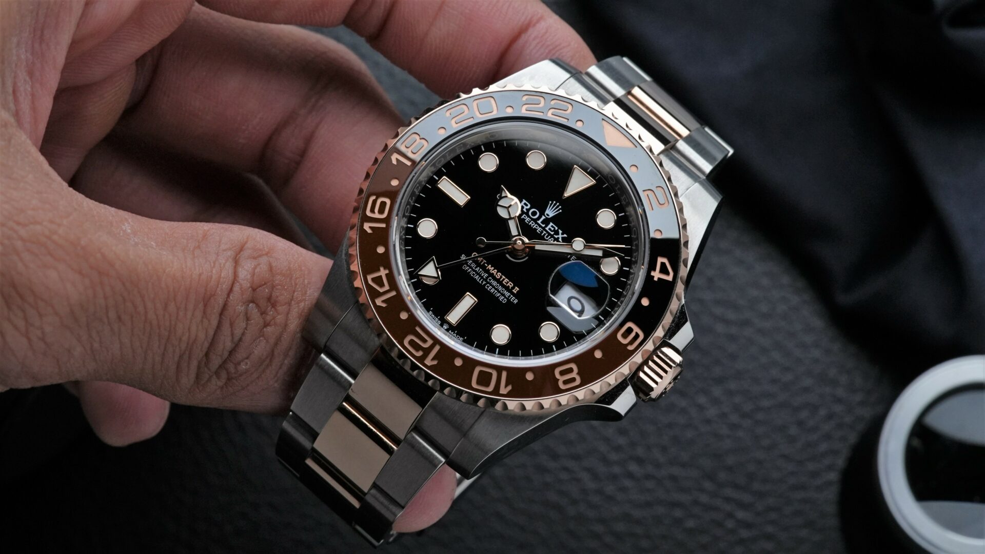 Rolex GMT-Master II Rootbeer Ceramic watch being held in hand.
