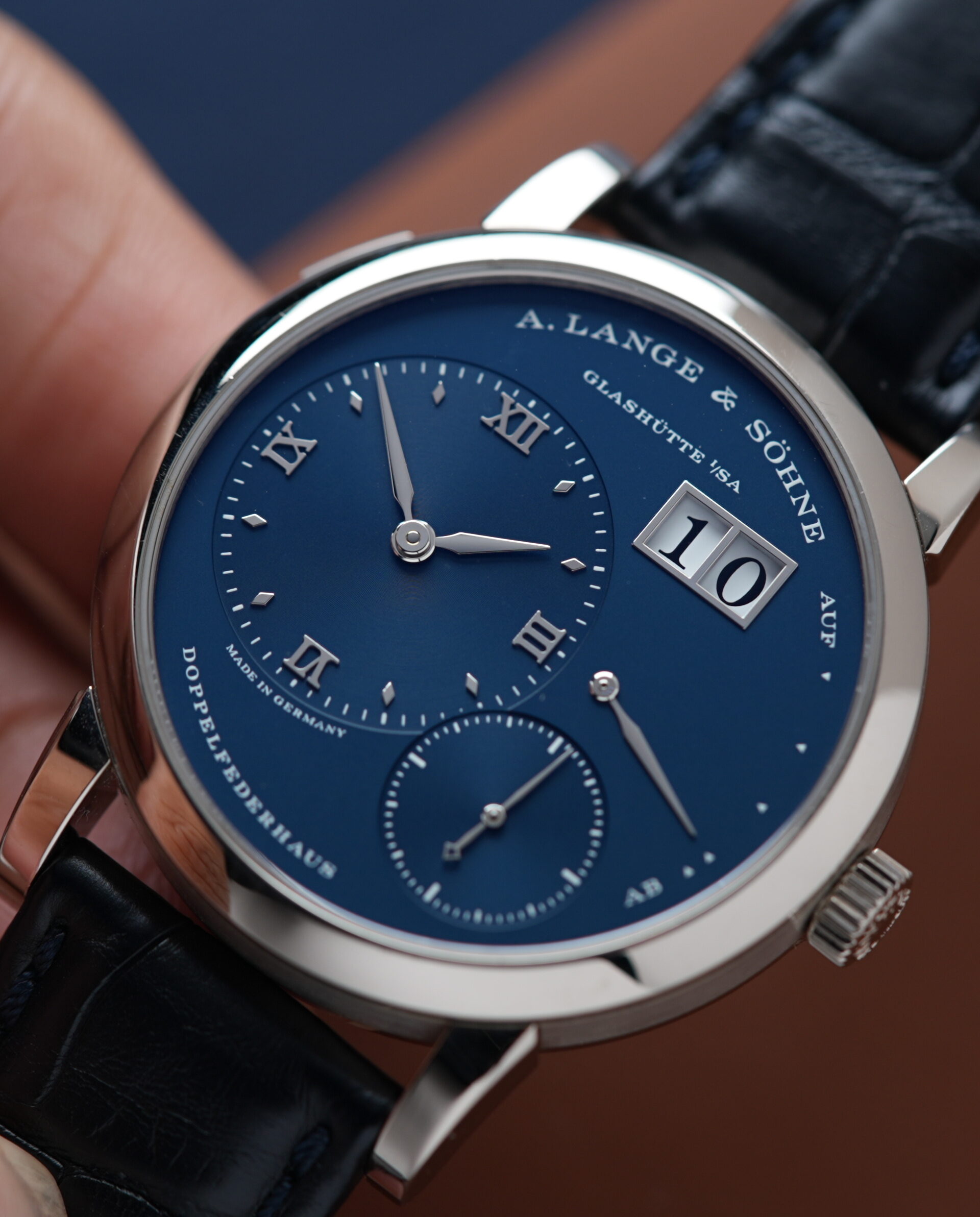 A. Lange & Söhne Lange 1 'Blue Series' 191.028 White Gold watch being held in hand.