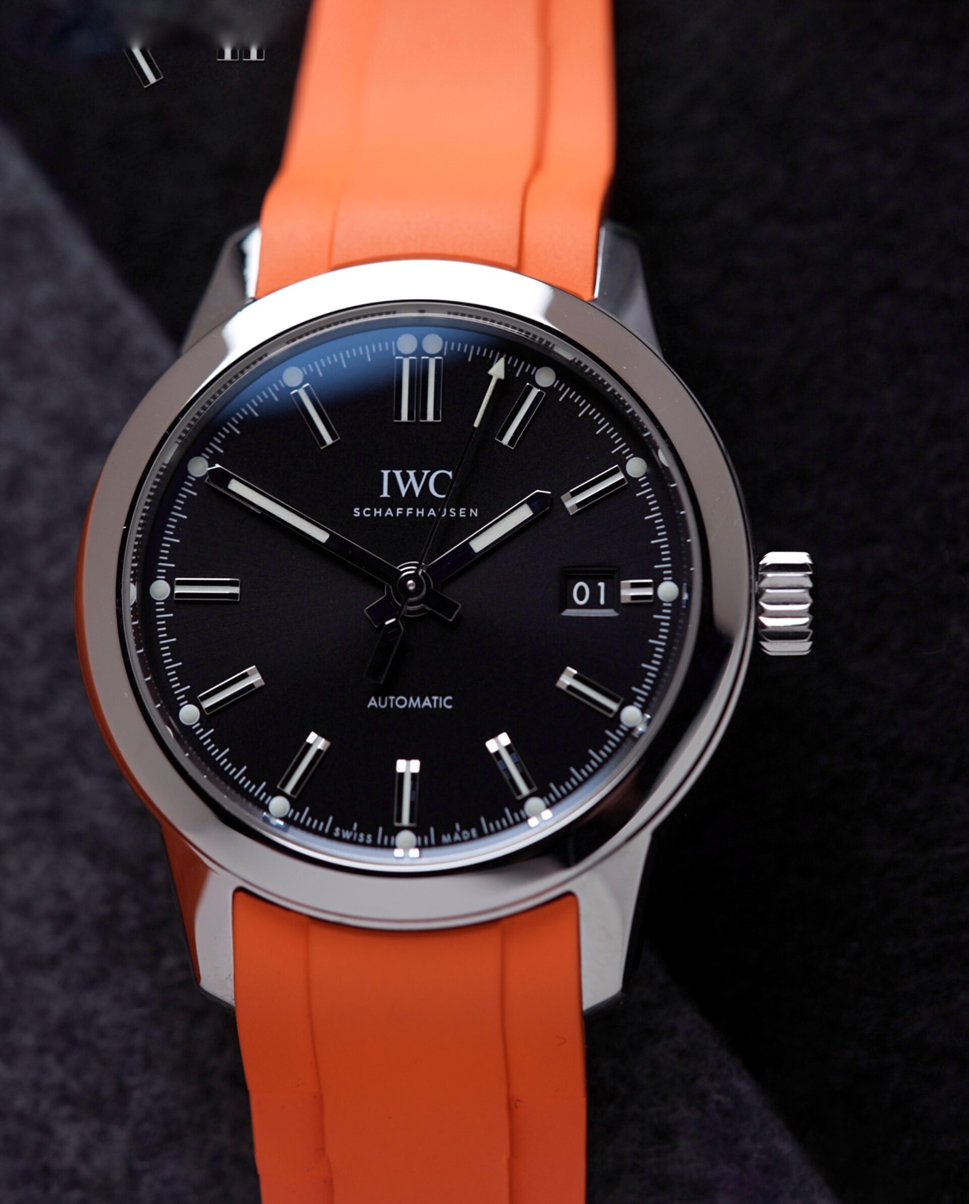 IWC Ingenieur Automatic 40MM 2021 On Bracelet & Extra Orange Rubber watch IW357002featured under white lighting.