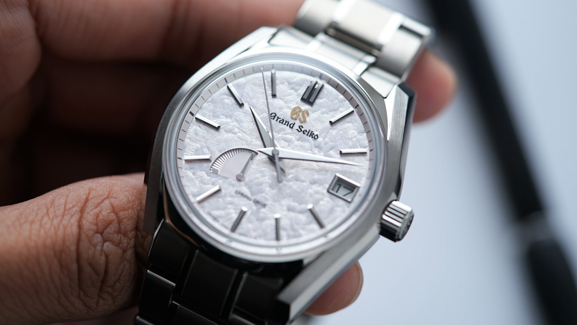 Grand Seiko Heritage Collection Seasons 'Spring' SBGA413 watch being held in hand.