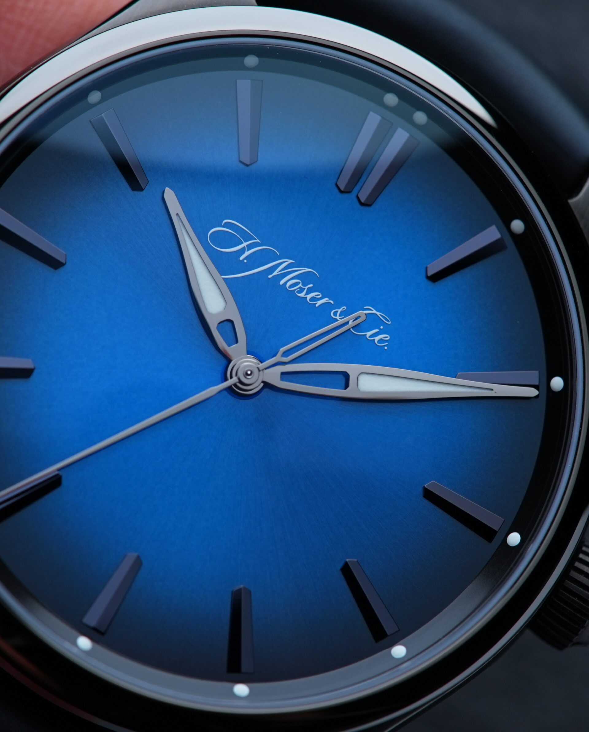 H.Moser & Cie. Pioneer Centre Seconds Funky Blue Fumé Black watch being held in hand.