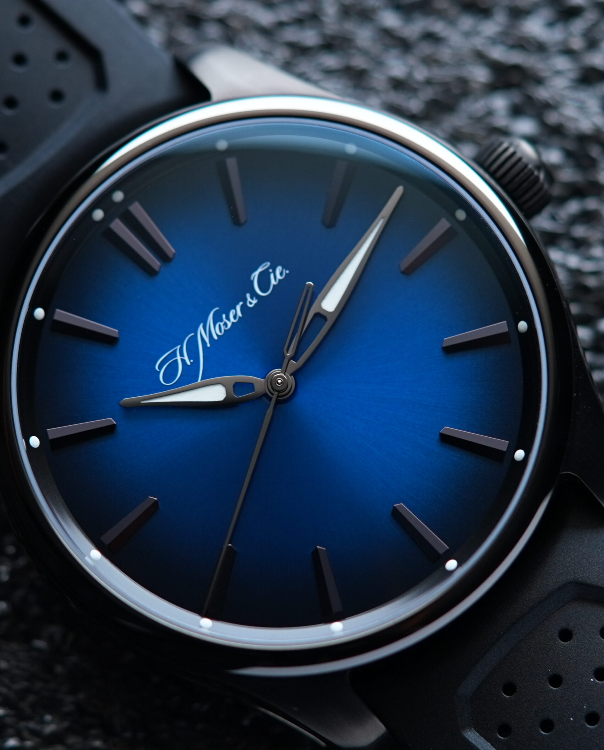 H.Moser & Cie. Pioneer Centre Seconds Funky Blue Fumé Black watch featured on an angle under white light.