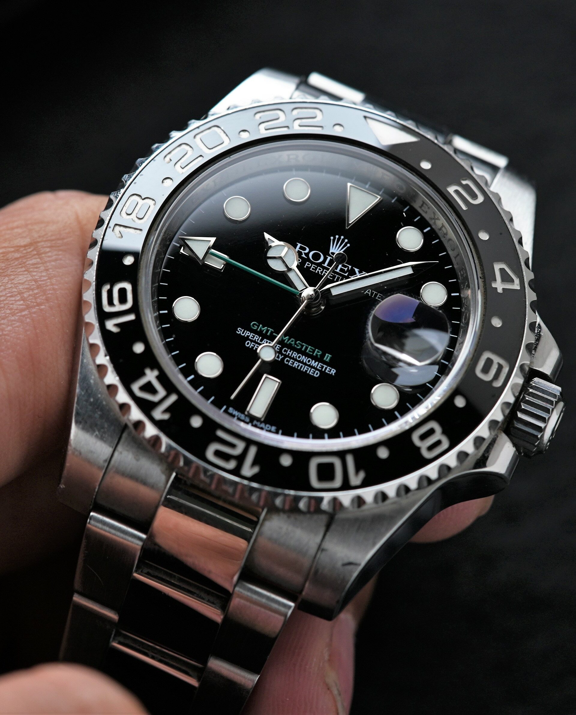 Rolex GMT-Master II Black Discontinued 116710LN wristwatch displayed in hand.