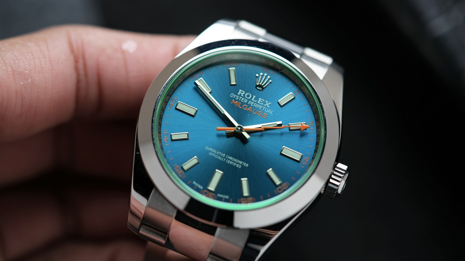 Rolex Milgauss Z Blue UNWORN 116400GV wristwatch displayed in hand.