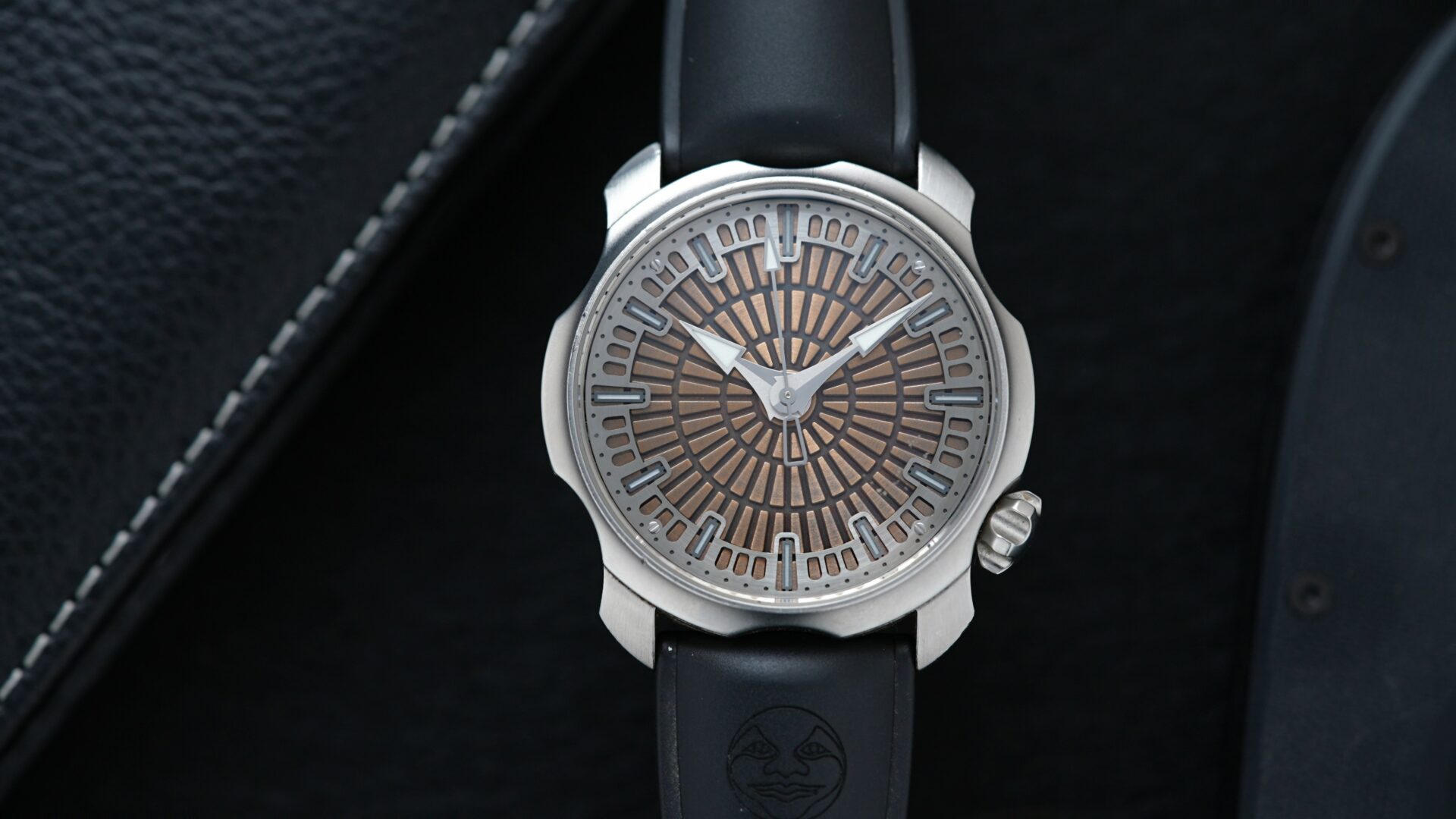 Sarpaneva Super1 watch featured under white light with binder in background.