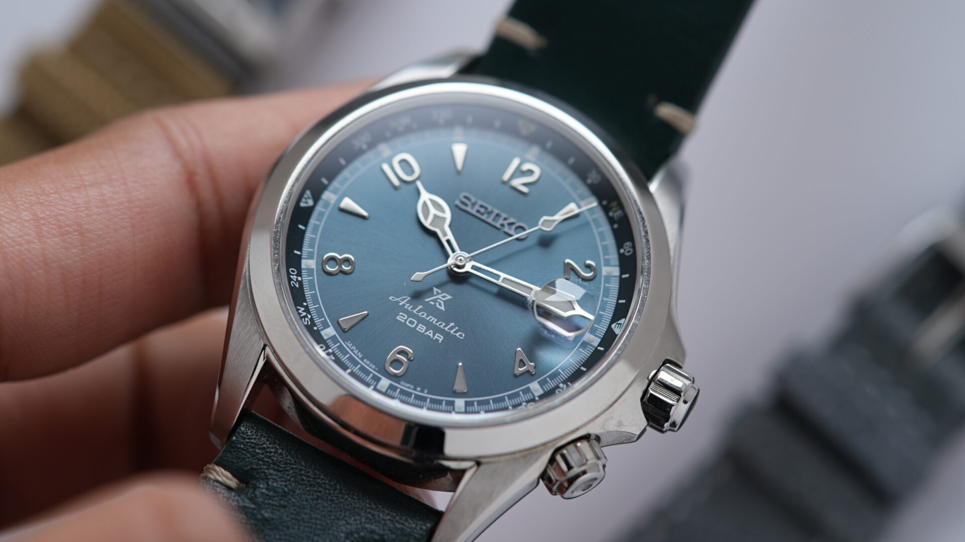 Seiko Alpinist Limited Edition Alpinist Mountain Glacier SPB199J1 watch being held in hand.