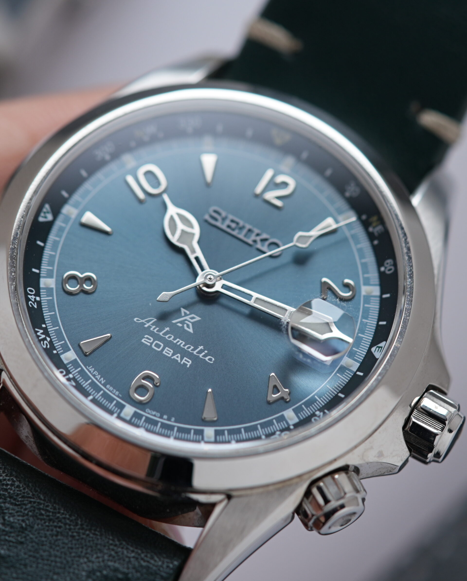 Seiko Alpinist Limited Edition Alpinist Mountain Glacier SPB199J1 watch being held in hand.