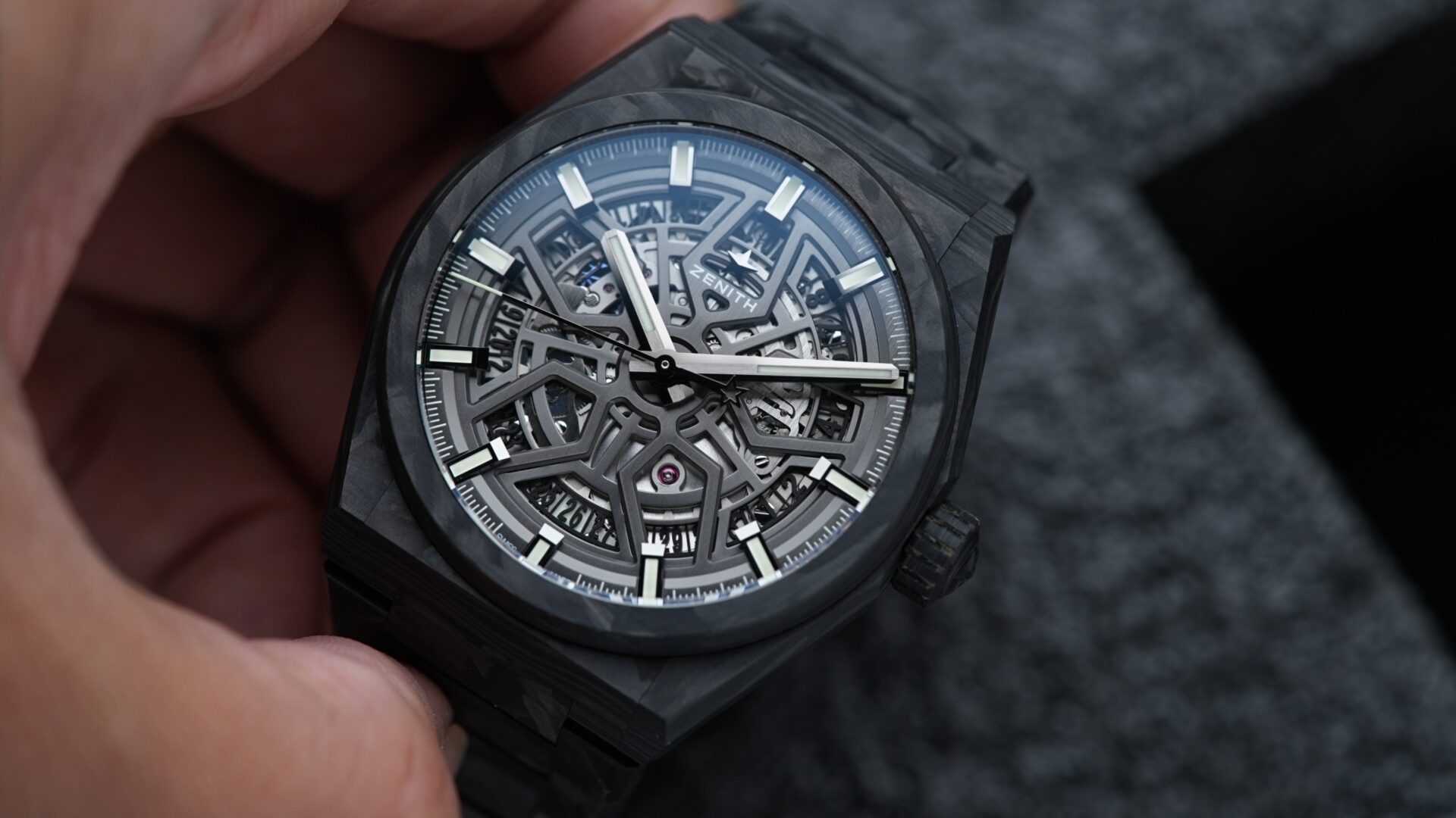 Zenith Defy Classic Carbon Fiber watch being held in hand.